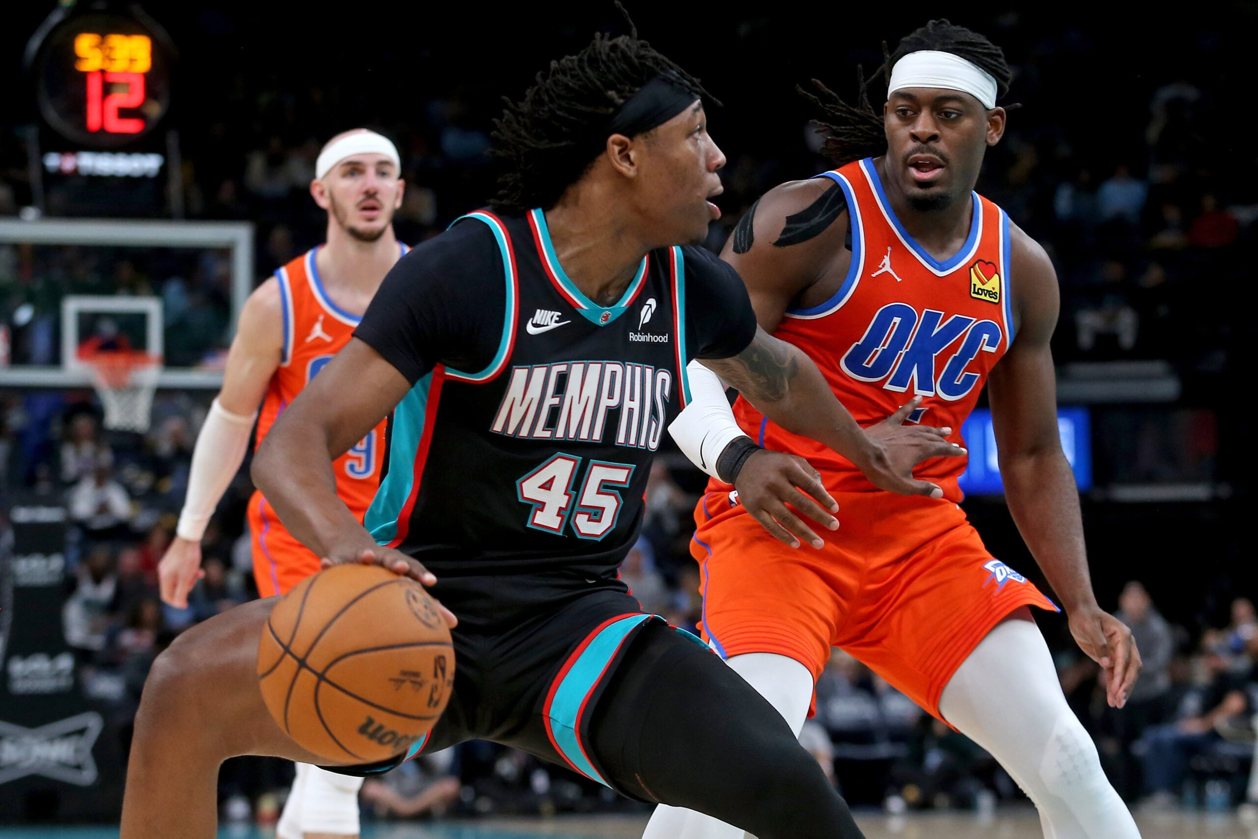 Jan 9, 2026; Memphis, Tennessee, USA; Memphis Grizzlies forward GG Jackson II (45) dribbles as Oklahoma City Thunder guard Luguentz Dort (5) defends during the fourth quarter at FedExForum. Mandatory Credit: Petre Thomas-Imagn Images