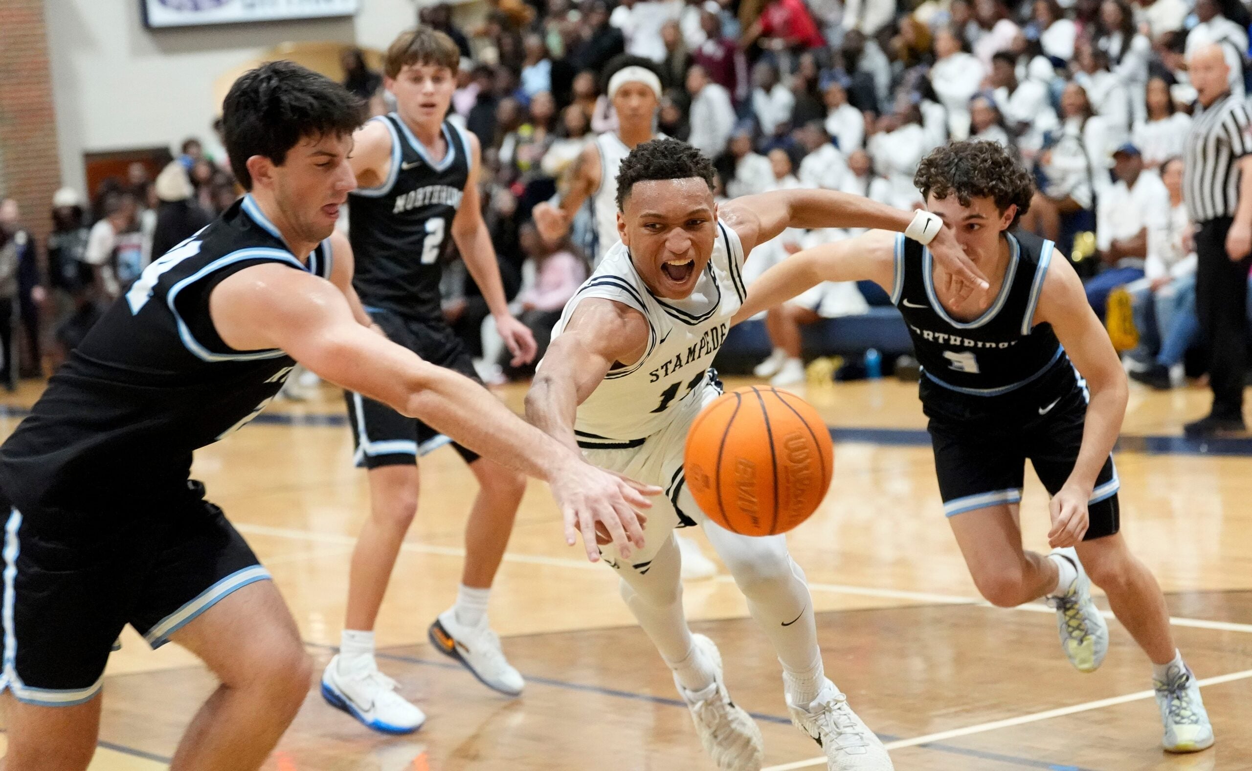 Jan 9, 2026; Tuscaloosa, AL, USA; Paul Bryant's Cameron Walton (11) chases a loose ball with Northridge's Adam Hall (24) and Northridge's James Walker (3) at Paul W. Bryant High.