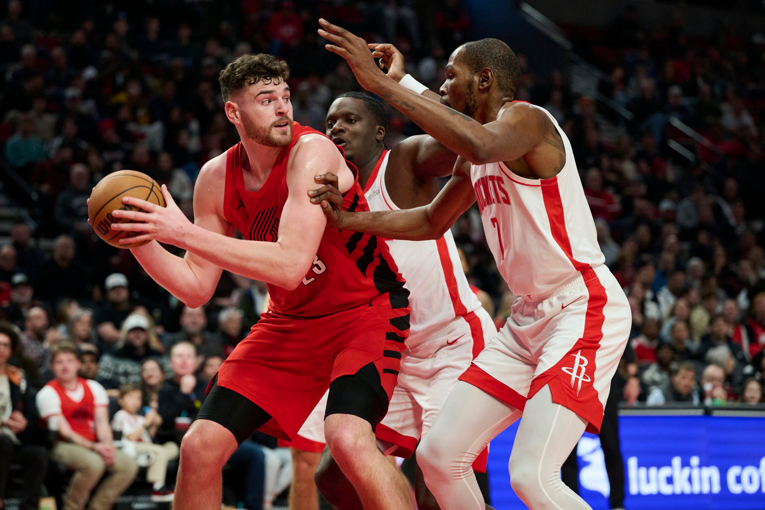Jan 9, 2026; Portland, Oregon, USA; Portland Trail Blazers center Donovan Clingan (23) looks to pass the ball during the second half against Houston Rockets center Clint Capela (30) and forward Kevin Durant (7) at Moda Center. Mandatory Credit: Troy Wayrynen-Imagn Images