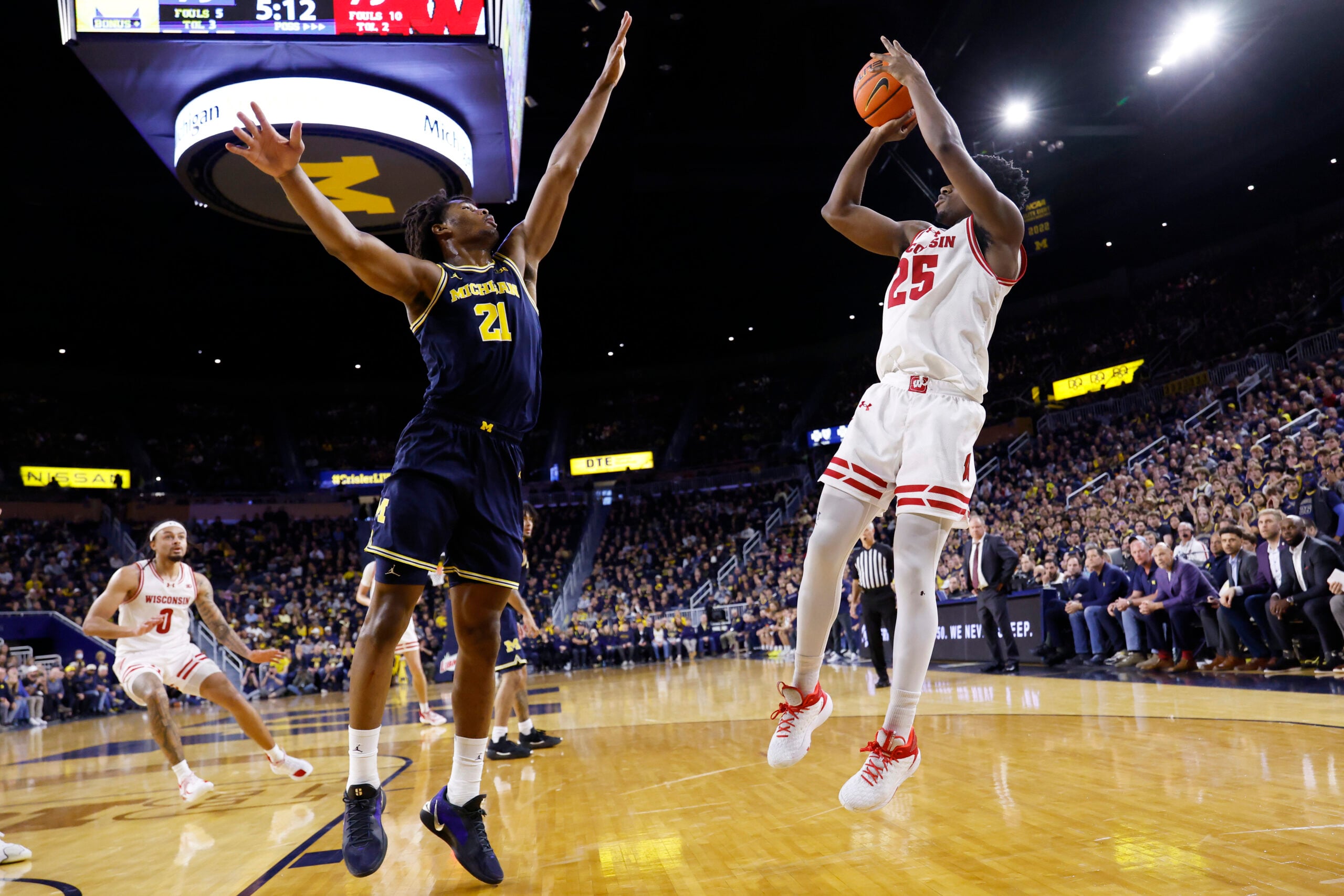 Jan 10, 2026; Ann Arbor, Michigan, USA;  Wisconsin Badgers guard John Blackwell (25) shoots on Michigan Wolverines forward Morez Johnson Jr. (21) in the second half at Crisler Center. Mandatory Credit: Rick Osentoski-Imagn Images