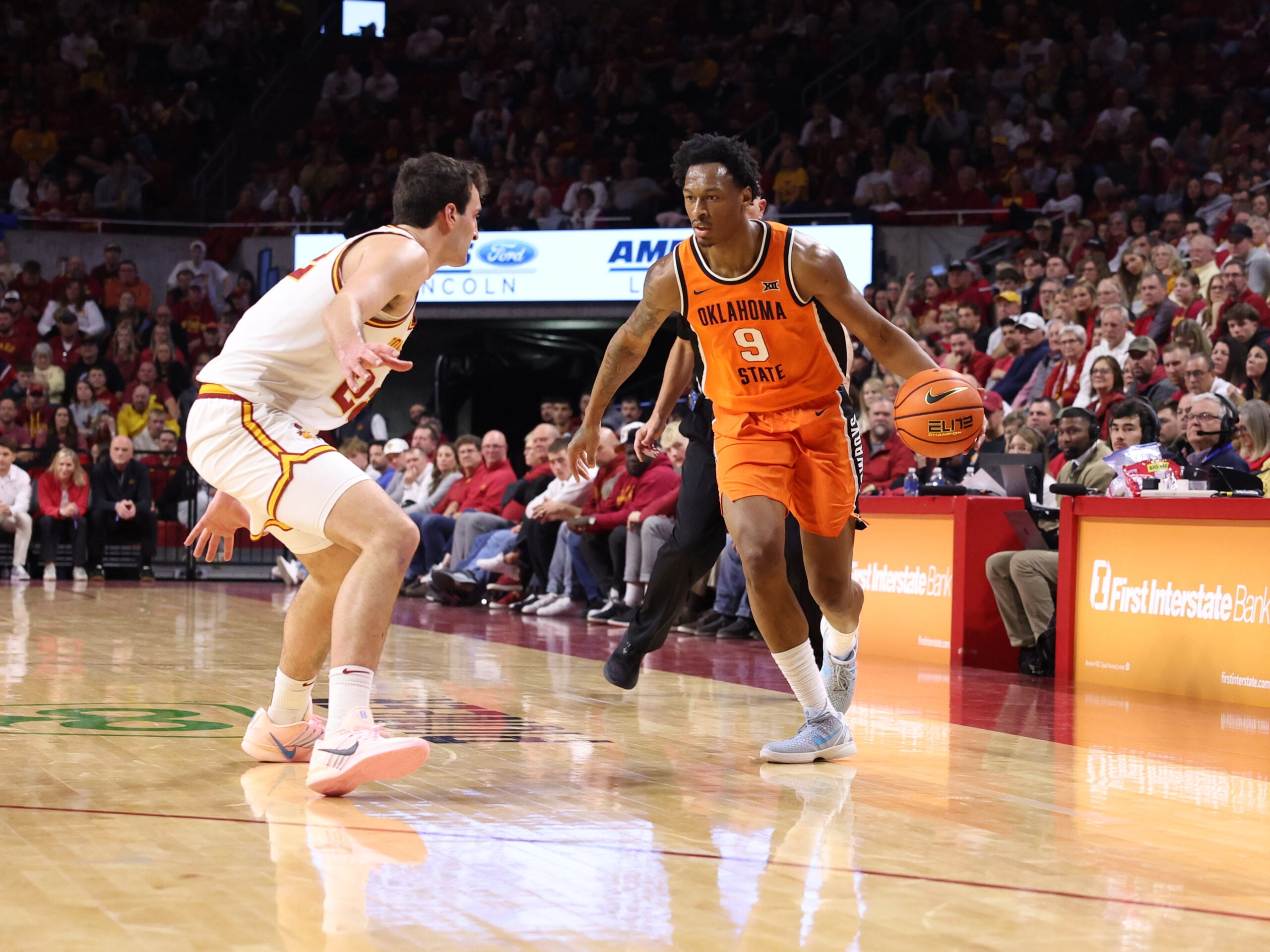 Jan 10, 2026; Ames, Iowa, USA; Iowa State Cyclones forward Milan Momcilovic (22) defends Oklahoma State Cowboys guard Anthony Roy (9) during the second half at James H. Hilton Coliseum. Mandatory Credit: Reese Strickland-Imagn Images