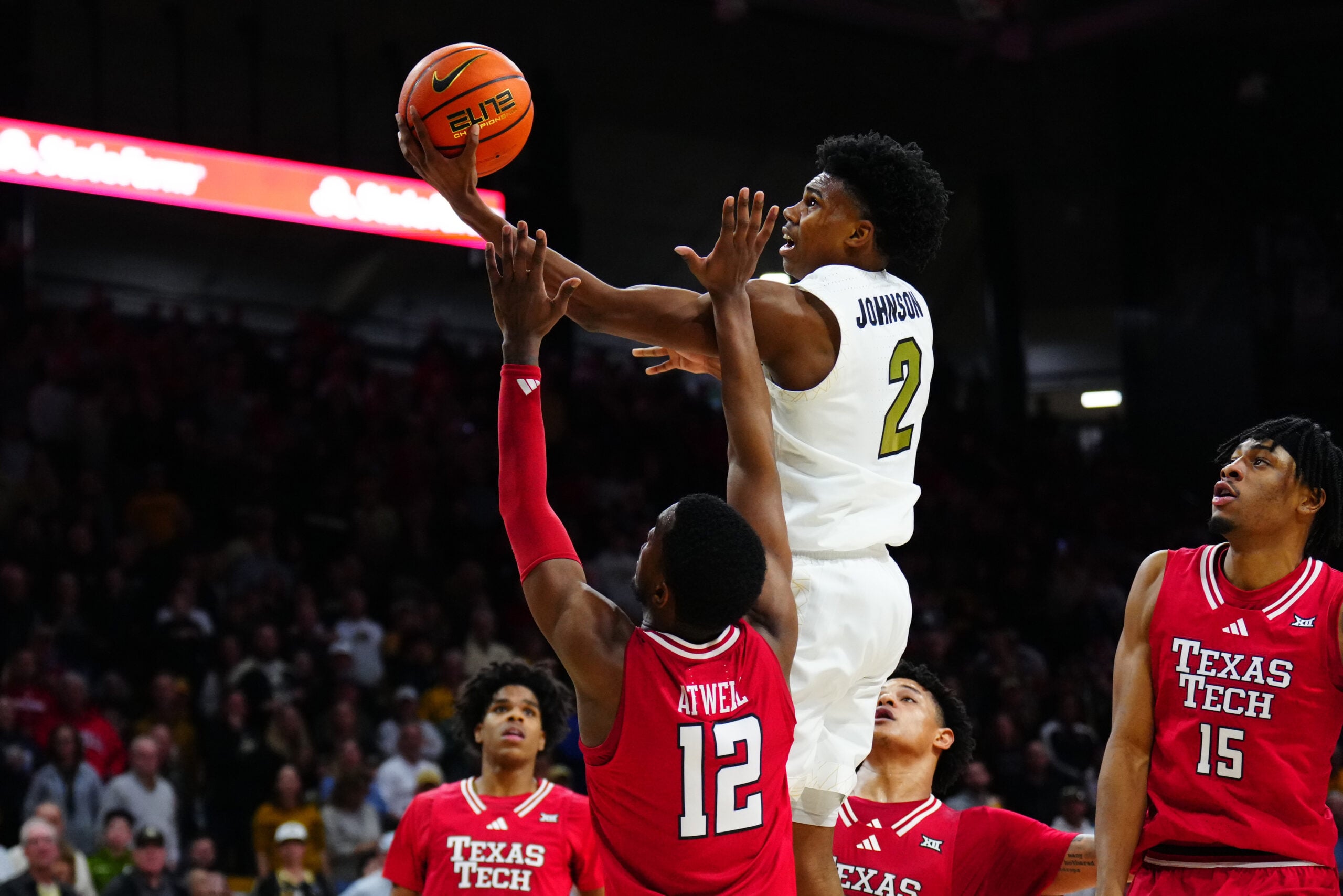 Jan 10, 2026; Boulder, Colorado, USA; Colorado Buffaloes guard Isaiah Johnson (2) shoots the ball over Texas Tech Red Raiders forward Donovan Atwell (12) in the second half at the CU Events Center. Mandatory Credit: Ron Chenoy-Imagn Images