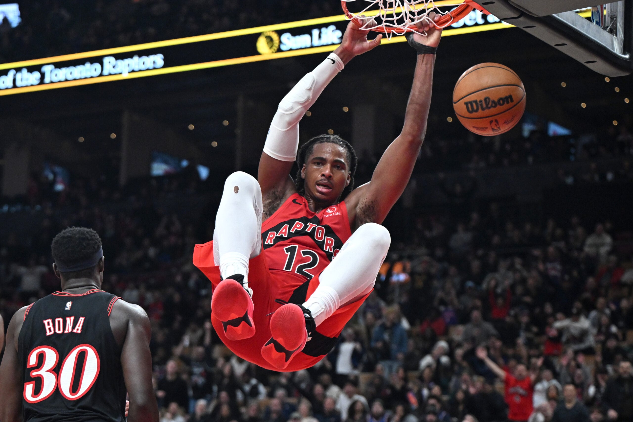 Jan 11, 2026; Toronto, Ontario, CAN;  Toronto Raptors forward Collin Murray-Boyles (12) dunks for a basket against the Philadelphia 76ers in the second half at Scotiabank Arena. Mandatory Credit: Dan Hamilton-Imagn Images