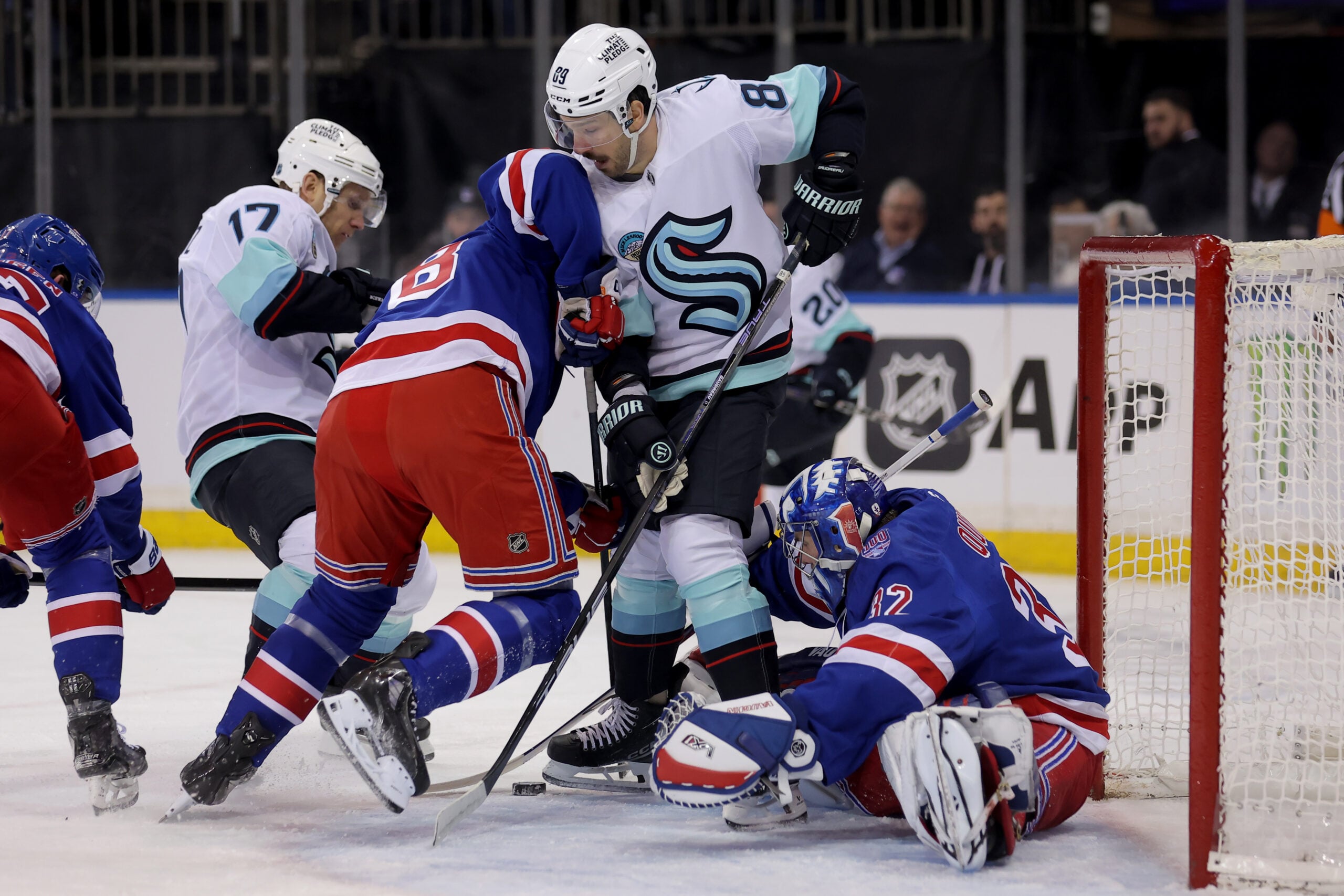 Jan 12, 2026; New York, New York, USA; New York Rangers goaltender Jonathan Quick (32) and left wing Brennan Othmann (78) fight for the puck against Seattle Kraken centers Jaden Schwartz (17) and Frederick Gaudreau (89) during the first period at Madison Square Garden. Mandatory Credit: Brad Penner-Imagn Images