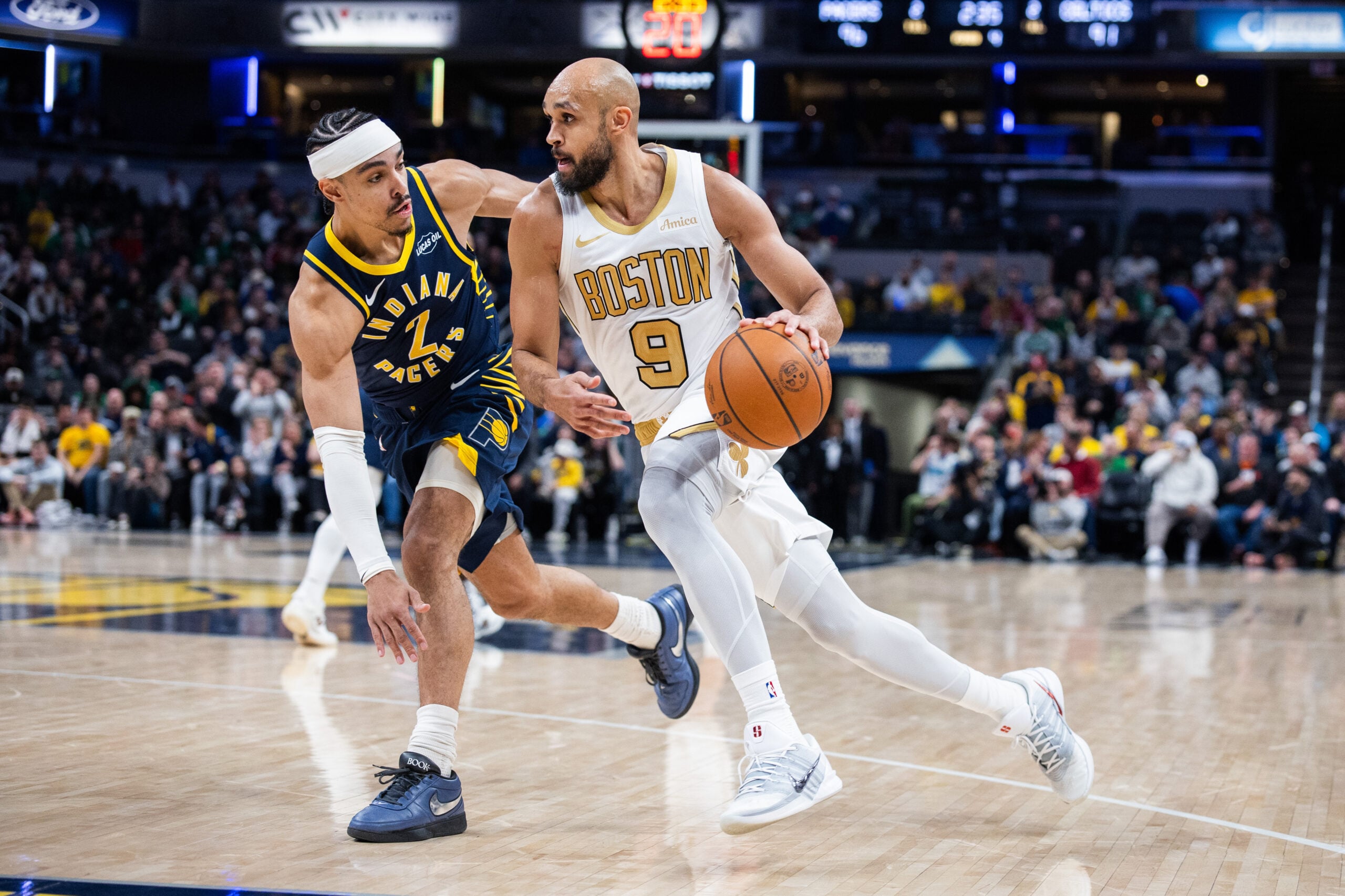 Jan 12, 2026; Indianapolis, Indiana, USA; Boston Celtics guard Derrick White (9) dribbles the ball while Indiana Pacers guard/forward Andrew Nembhard (2) defends in the second half at Gainbridge Fieldhouse. Mandatory Credit: Trevor Ruszkowski-Imagn Images