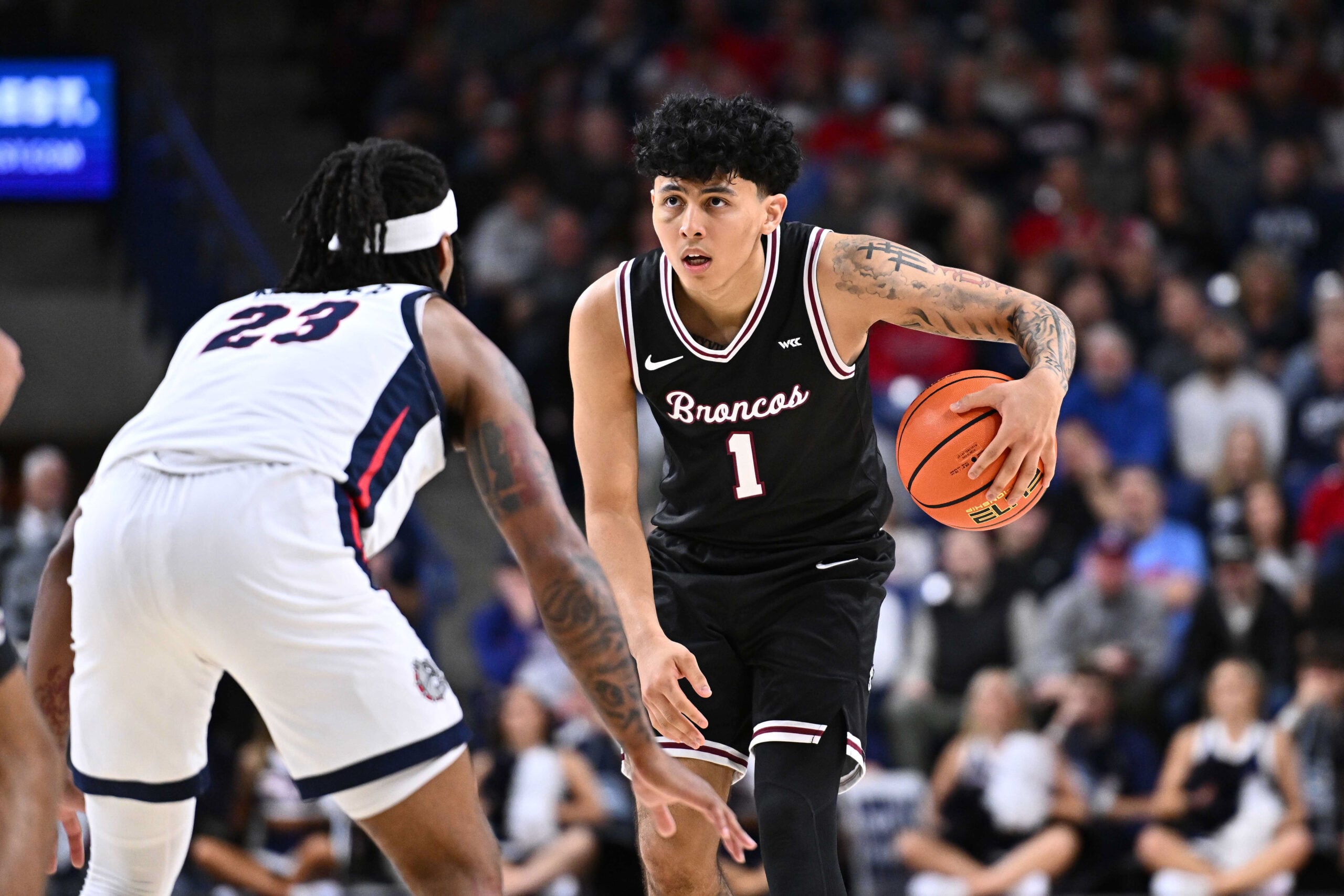 Jan 8, 2026; Spokane, Washington, USA; Santa Clara Broncos guard Christian Hammond (1) controls the ball against Gonzaga Bulldogs guard Adam Miller (23) in the second half at McCarthey Athletic Center. Mandatory Credit: James Snook-Imagn Images