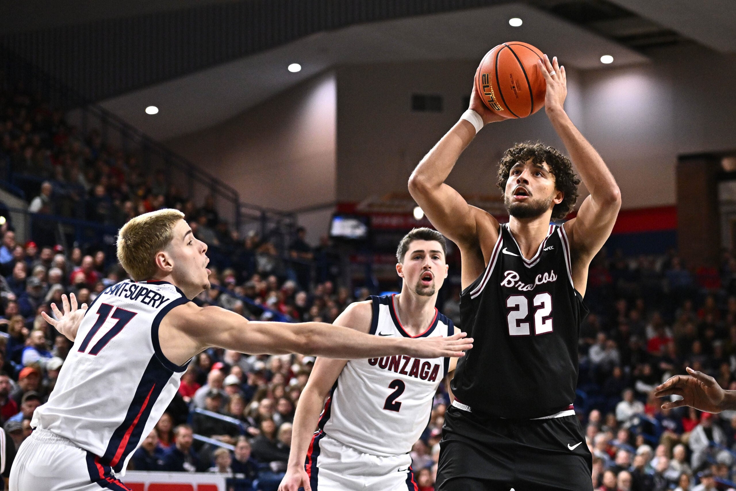 Jan 8, 2026; Spokane, Washington, USA; Santa Clara Broncos forward Allen Graves (22) shoots the ball against Gonzaga Bulldogs guard Mario Saint-Supery (17) in the second half at McCarthey Athletic Center. Mandatory Credit: James Snook-Imagn Images