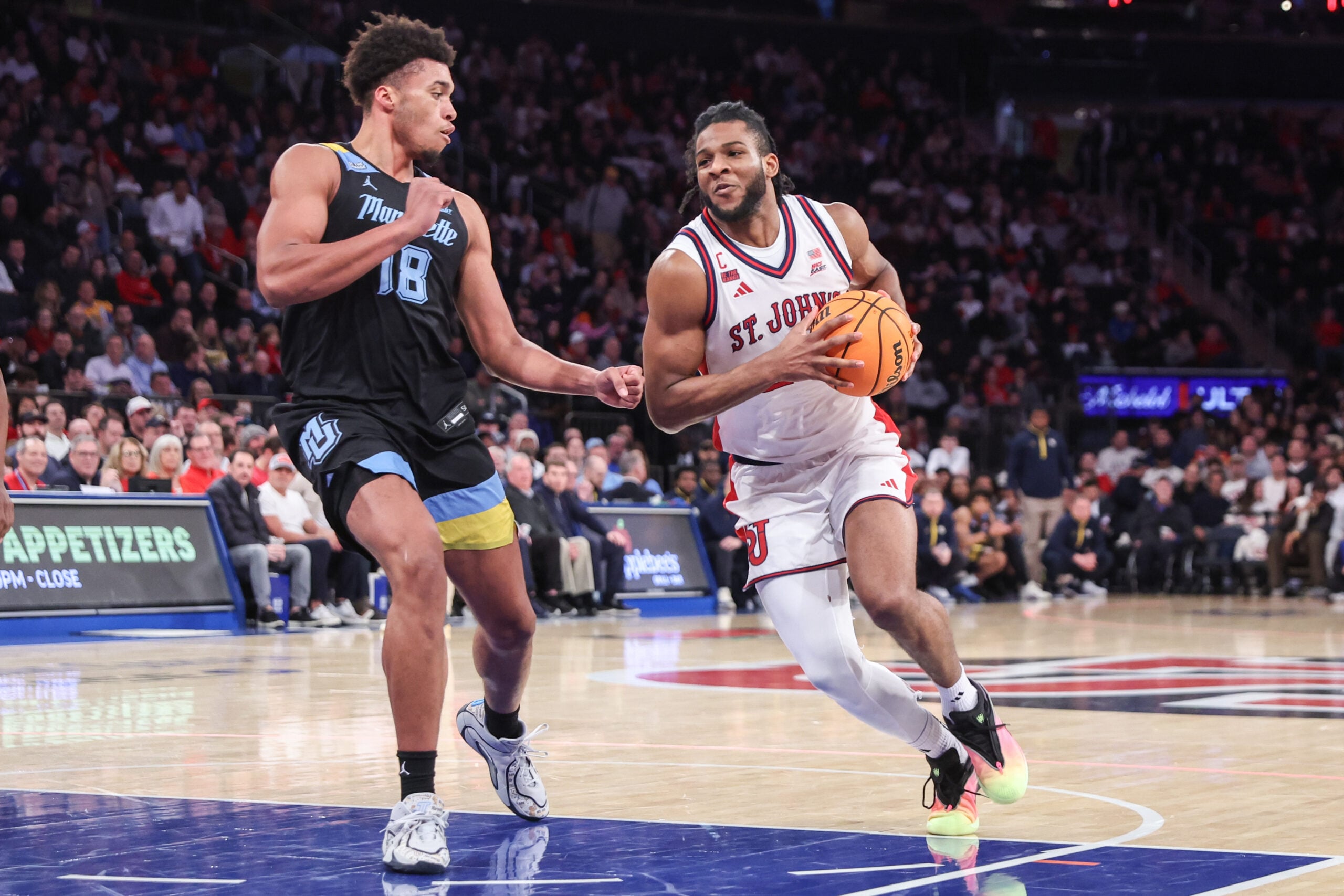 Jan 13, 2026; New York, New York, USA;  St. John's Red Storm forward Zuby Ejiofor (24) drives past Marquette Golden Eagles forward Caedin Hamilton (18) in the second half at Madison Square Garden Mandatory Credit: Wendell Cruz-Imagn Images
