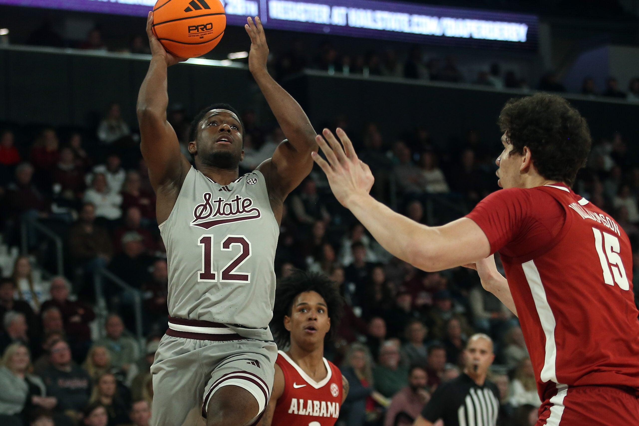 Jan 13, 2026; Starkville, Mississippi, USA; Mississippi State Bulldogs guard Josh Hubbard (12) shoots as Alabama Crimson Tide center Noah Williamson (15) defends during the first half at Humphrey Coliseum. Mandatory Credit: Petre Thomas-Imagn Images