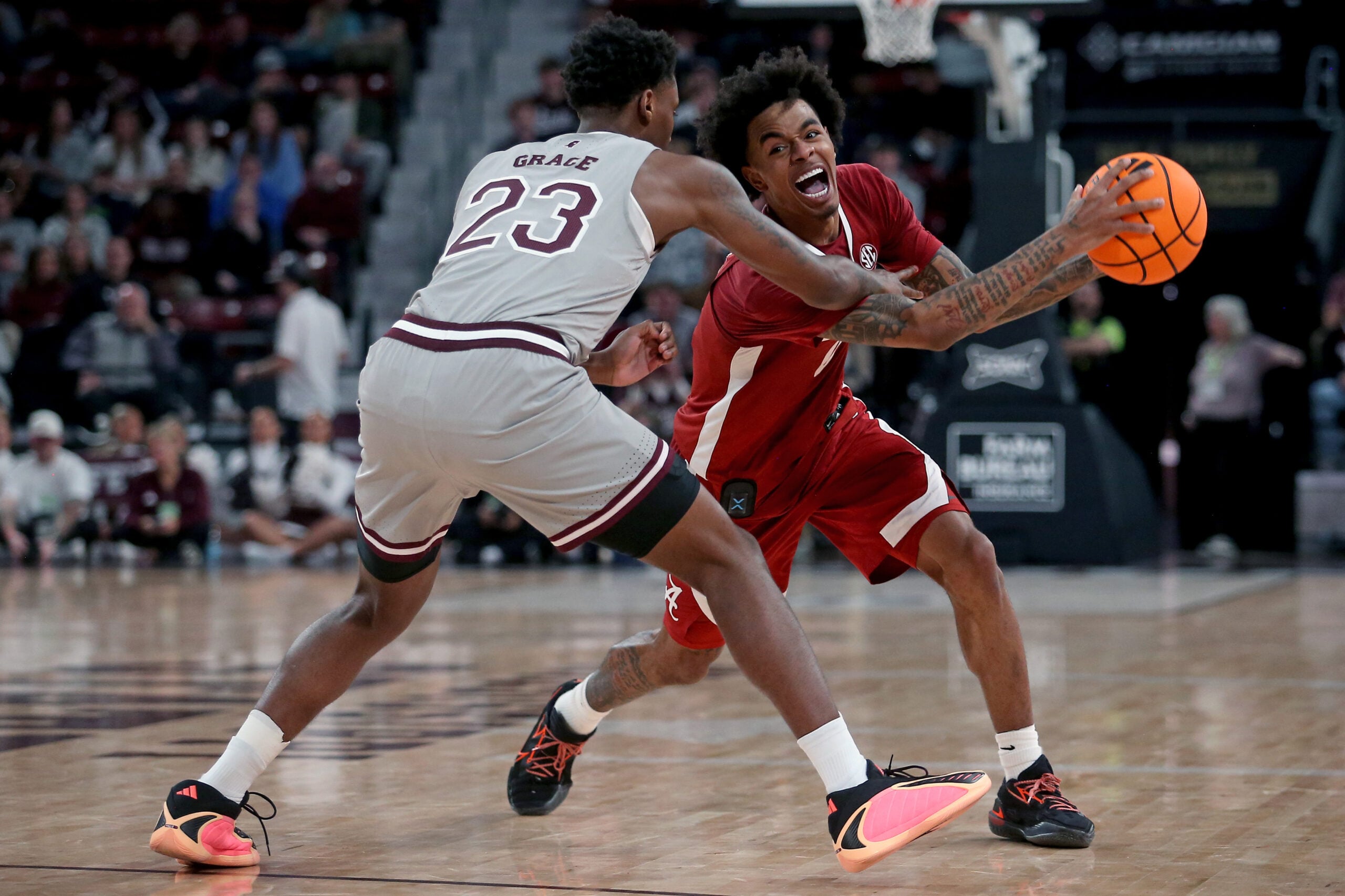 Jan 13, 2026; Starkville, Mississippi, USA; Alabama Crimson Tide guard Labaron Philon Jr. (0) handles the ball as Mississippi State Bulldogs guard King Grace (23) defends during the second half at Humphrey Coliseum. Mandatory Credit: Petre Thomas-Imagn Images