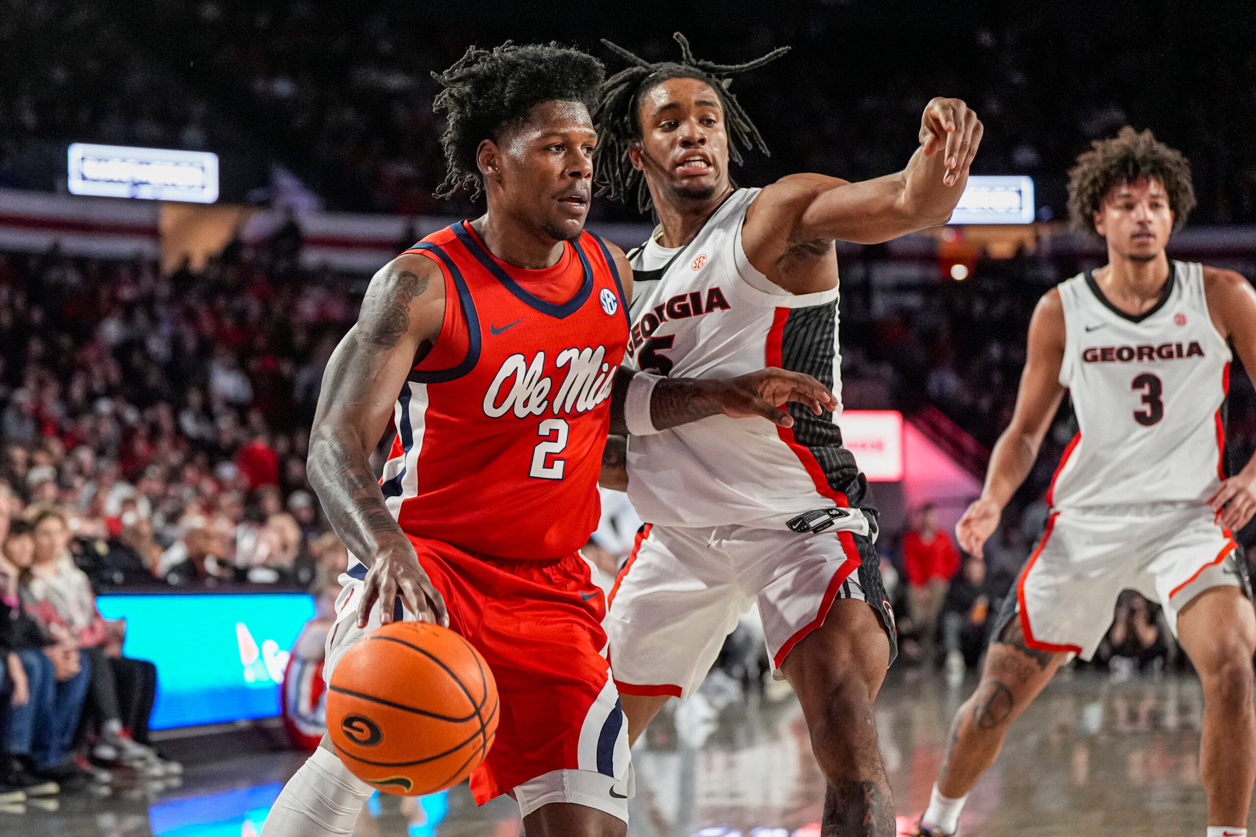 Jan 14, 2026; Athens, Georgia, USA; Mississippi Rebels guard AJ Storr (2) dribbles defended by Georgia Bulldogs guard Jeremiah Wilkinson (5) during the first half at Stegeman Coliseum. Mandatory Credit: Dale Zanine-Imagn Images