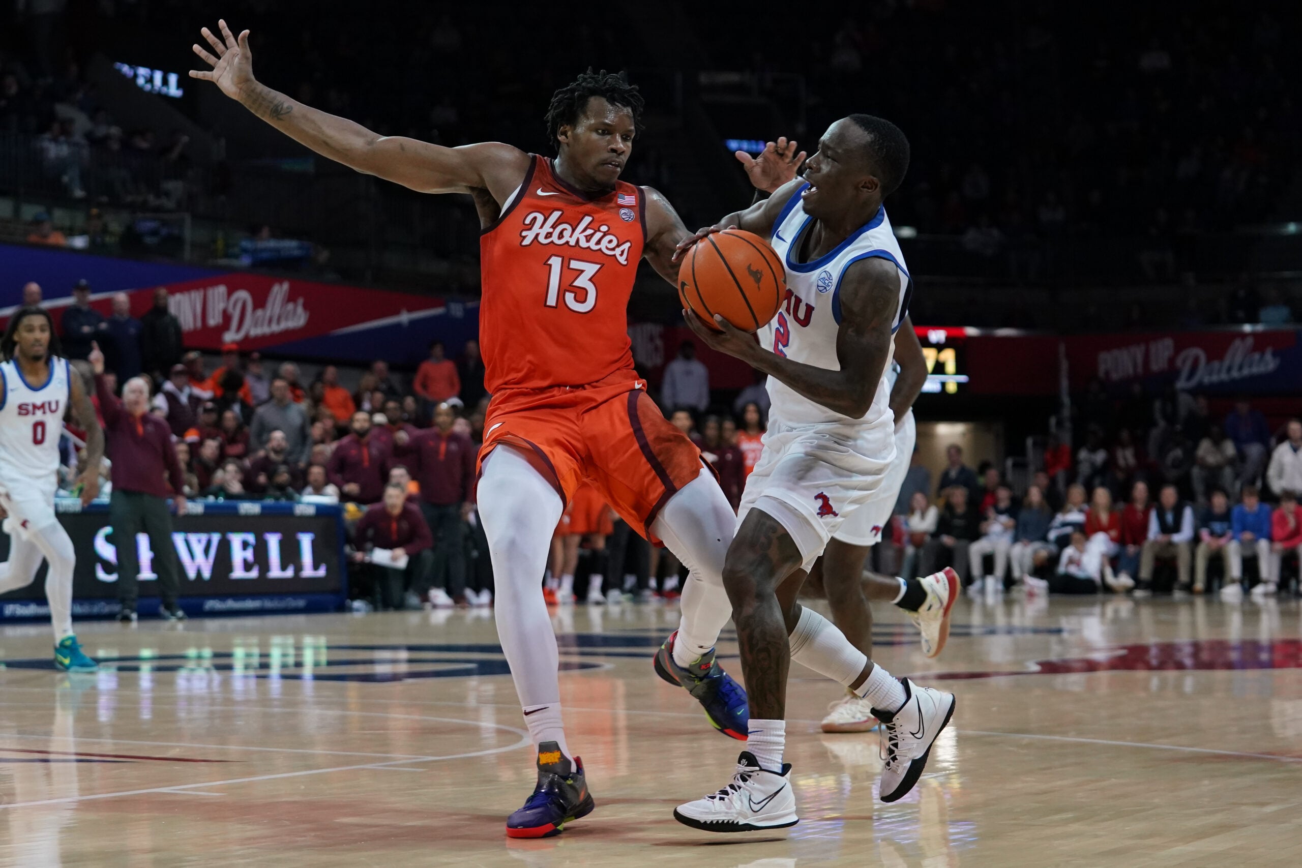 Jan 14, 2026; Dallas, Texas, USA;  SMU Mustangs guard Boopie Miller (2) is fouled by Virginia Tech Hokies forward Amani Hansberry (13) during the second half at Moody Coliseum. Mandatory Credit: Raymond Carlin III-Imagn Images