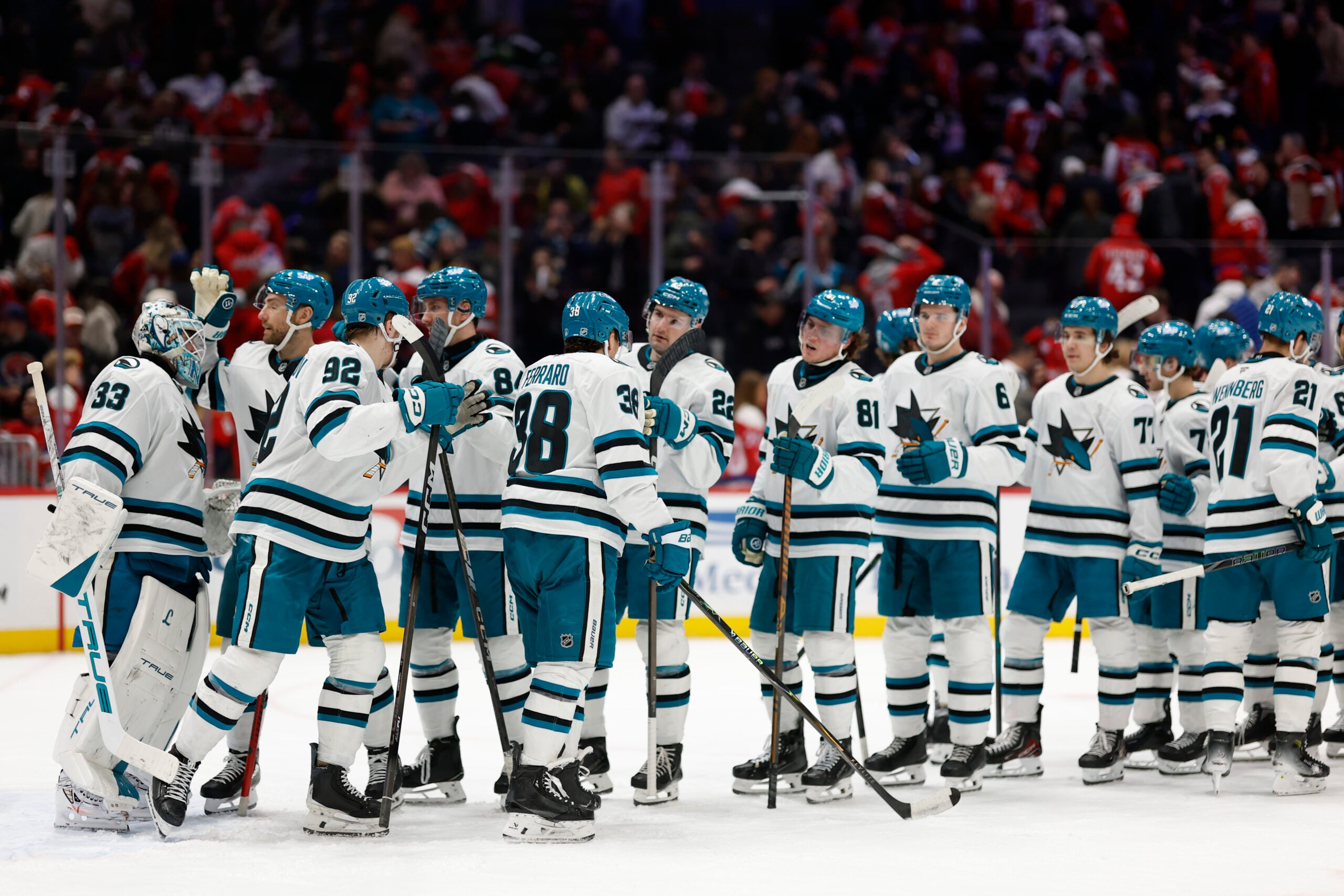 Jan 15, 2026; Washington, District of Columbia, USA; San Jose Sharks goaltender Alex Nedeljkovic (33) celebrates with teammates after their game against the Washington Capitals at Capital One Arena. Mandatory Credit: Geoff Burke-Imagn Images