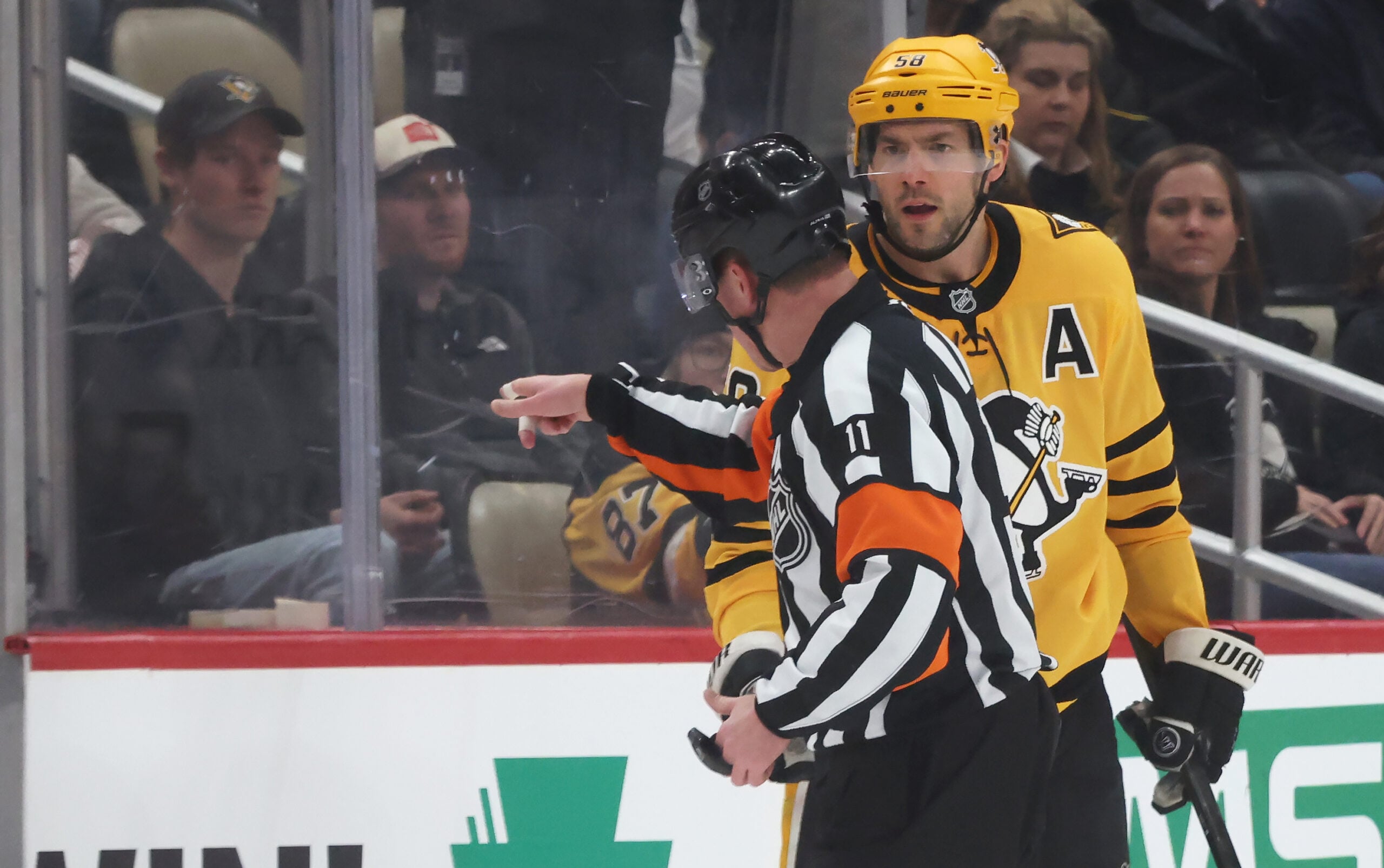 Jan 15, 2026; Pittsburgh, Pennsylvania, USA;  Pittsburgh Penguins defenseman Kris Letang (58) reacts a to referee Kelly Sutherland (11) after being penalized for boarding against the Philadelphia Flyers during the third period at PPG Paints Arena. Mandatory Credit: Charles LeClaire-Imagn Images