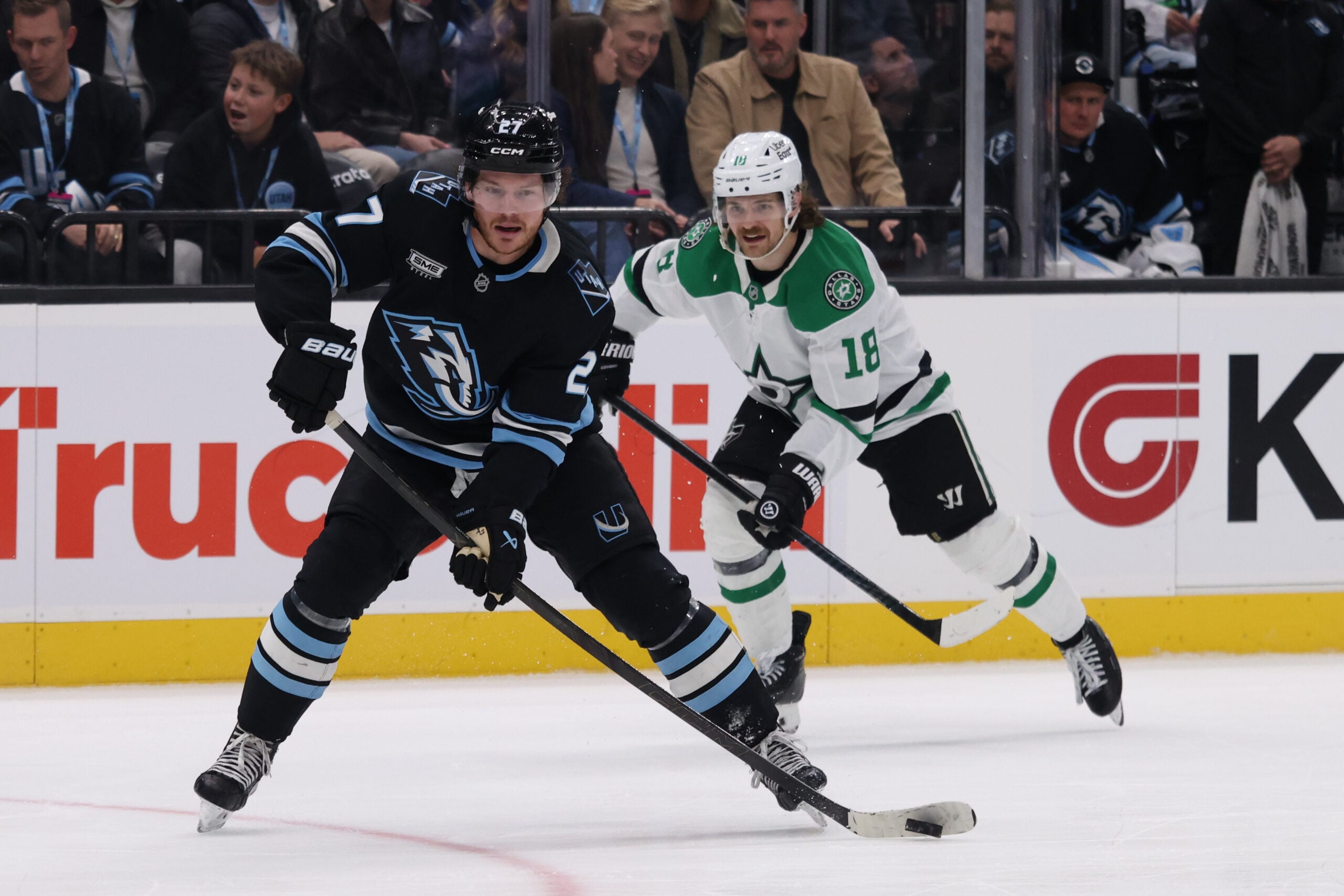 Jan 15, 2026; Salt Lake City, Utah, USA; Utah Mammoth center Barrett Hayton (27) looks to pass the puck against Dallas Stars center Sam Steel (18) during the second period at Delta Center. Mandatory Credit: Rob Gray-Imagn Images