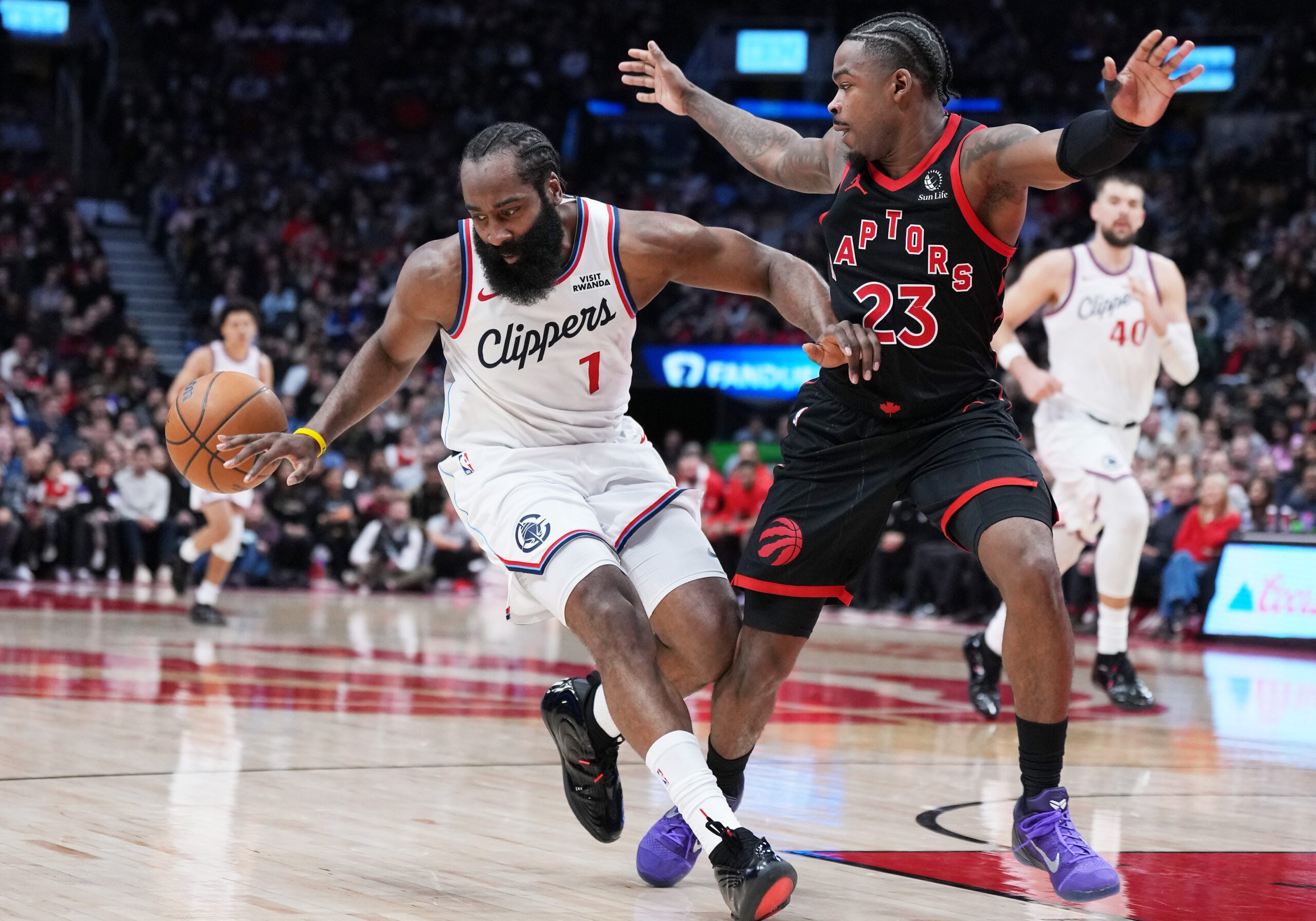 Jan 16, 2026; Toronto, Ontario, CAN; LA Clippers guard James Harden (1) controls the ball as Toronto Raptors guard Jamal Shead (23) tries to defend during the fourth quarter at Scotiabank Arena. Mandatory Credit: Nick Turchiaro-Imagn Images