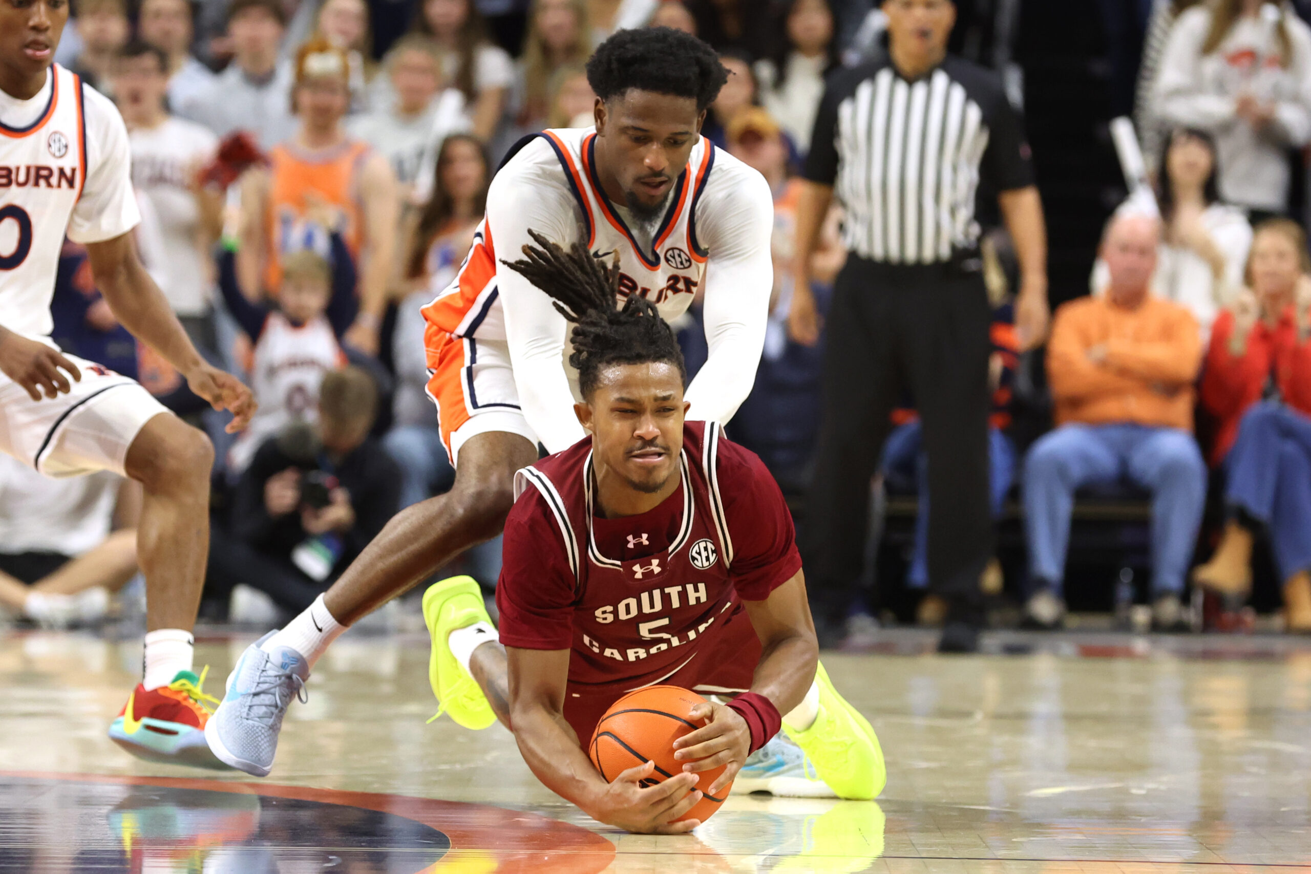 Jan 17, 2026; Auburn, Alabama, USA;  South Carolina Gamecocks guard Meechie Johnson (5) beats Auburn Tigers guard Kevin Overton (1) to a loose ball during the second half at Neville Arena. Mandatory Credit: John Reed-Imagn Images