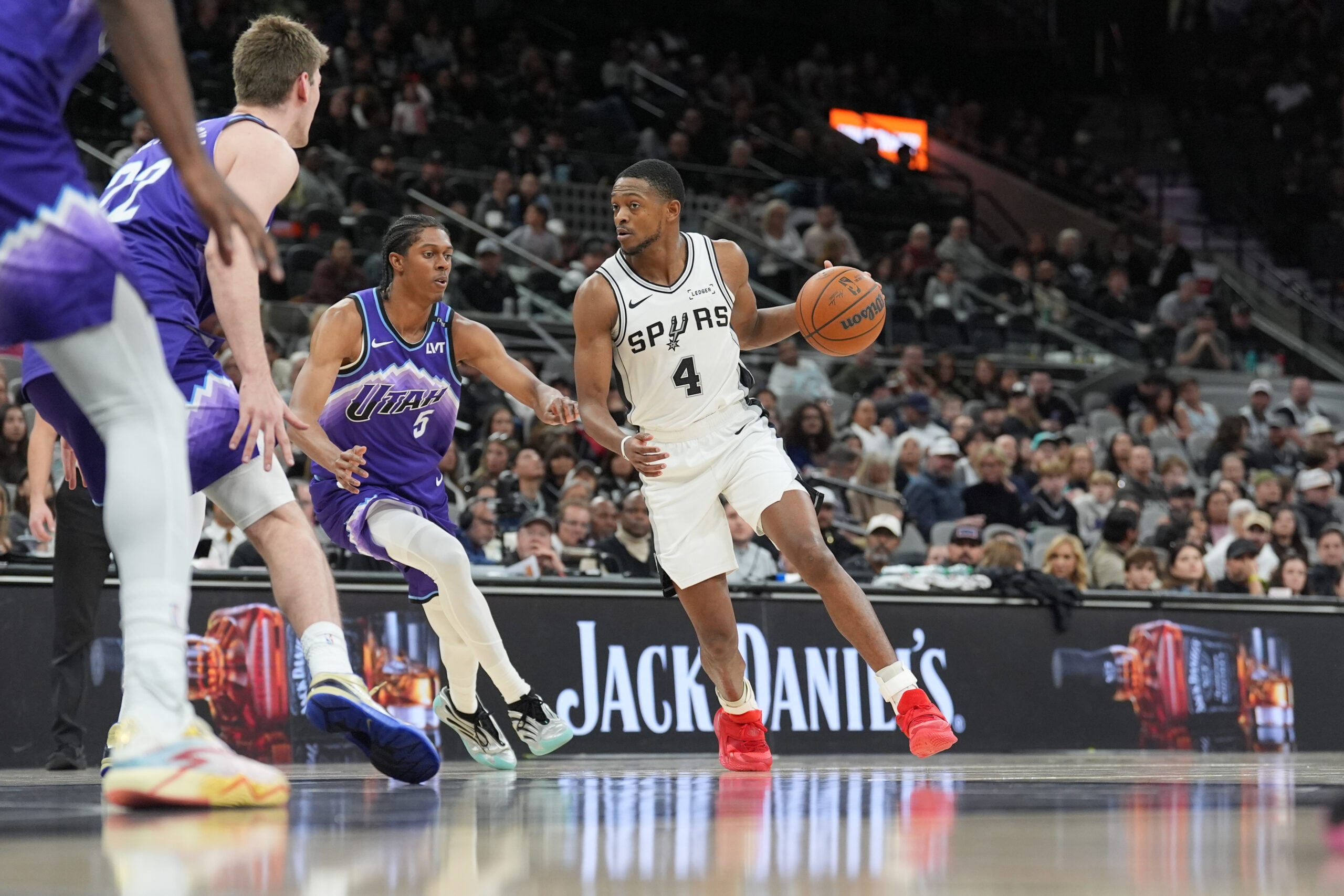 Jan 19, 2026; San Antonio, Texas, USA; San Antonio Spurs guard De'aaron Fox (4) dribbles the ball against Utah Jazz forward Cody Williams (5) during the second half at Frost Bank Center. Mandatory Credit: Daniel Dunn-Imagn Images