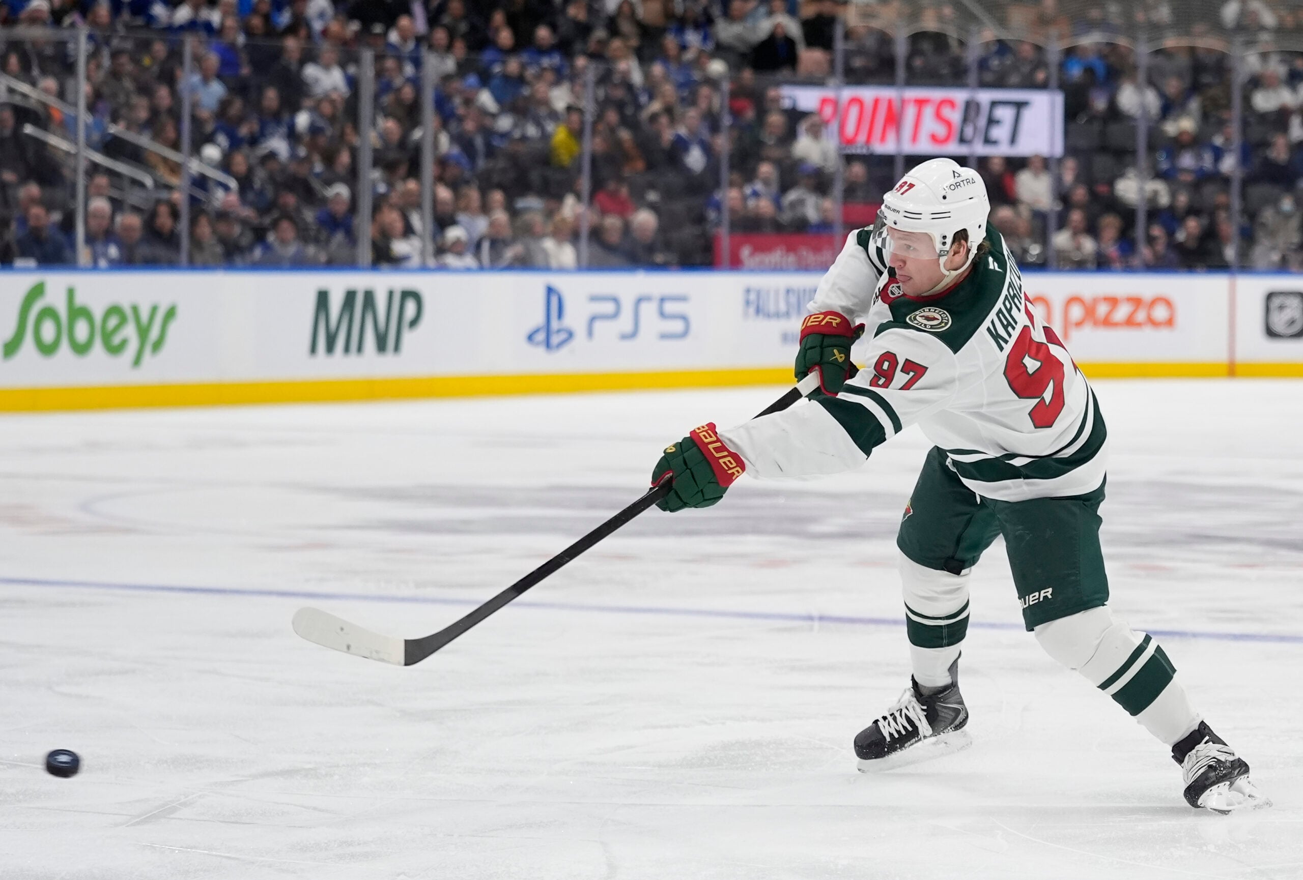 Jan 19, 2026; Toronto, Ontario, CAN; Minnesota Wild forward Kirill Kaprizov (97) shoots the puck against the Toronto Maple Leafs during the second period at Scotiabank Arena. Mandatory Credit: John E. Sokolowski-Imagn Images