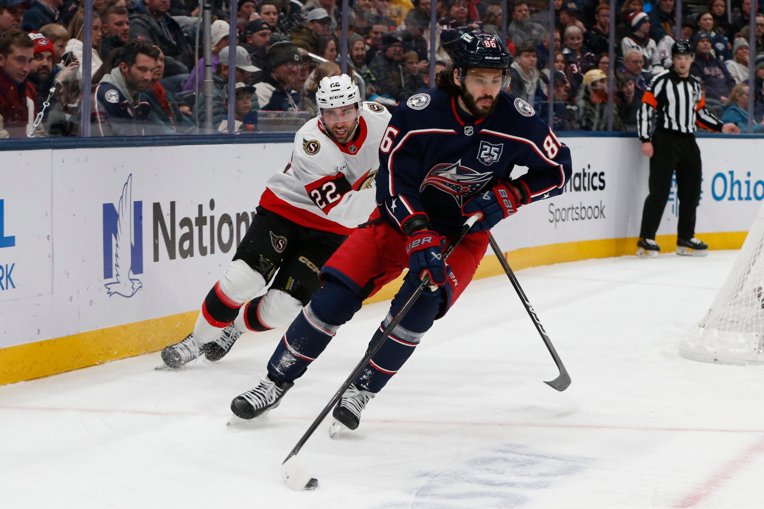Jan 20, 2026; Columbus, Ohio, USA; Columbus Blue Jackets right wing Kirill Marchenko (86) carries the puck as Ottawa Senators center Michael Amadio (22) trails the play during the first period at Nationwide Arena. Mandatory Credit: Russell LaBounty-Imagn Images