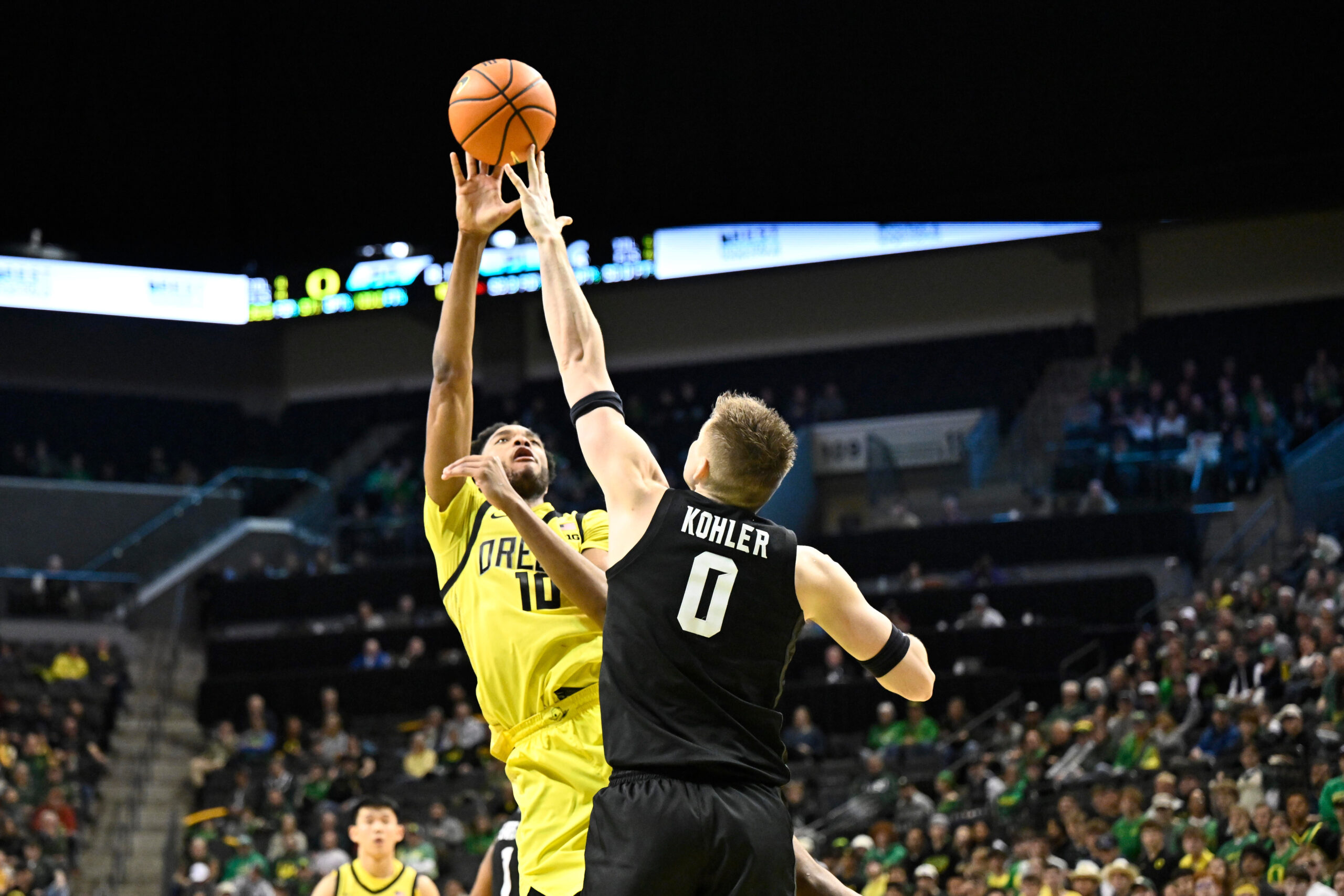 Jan 20, 2026; Eugene, Oregon, USA; Michigan State Spartans forward Jaxon Kohler (0) blocks a shot by Oregon Ducks forward Kwame Evans Jr. (10) during the first half at Matthew Knight Arena. Mandatory Credit: Craig Strobeck-Imagn Images