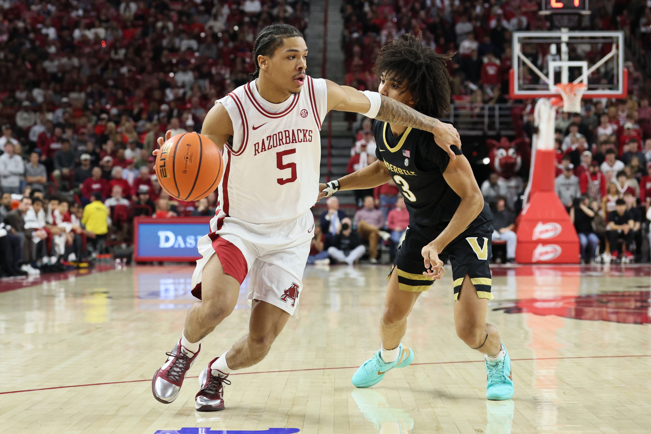 Jan 20, 2026; Fayetteville, Arkansas, USA; Arkansas Razorbacks guard Darius Acuff Jr (5) drives against Vanderbilt Commodores guard Tyler Tanner (3) during the first half against at Bud Walton Arena. Mandatory Credit: Nelson Chenault-Imagn Images