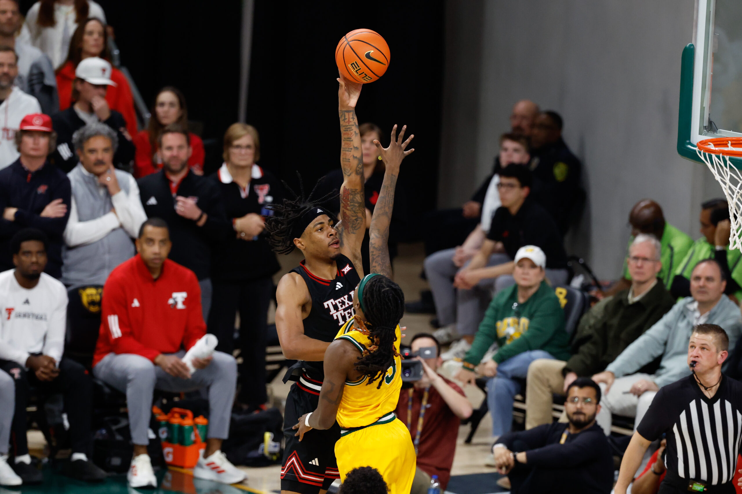 Jan 20, 2026; Waco, Texas, USA;  Texas Tech Red Raiders forward JT Toppin (15) scores a basket over Baylor Bears guard Obi Agbim (5) during the second half at Paul and Alejandra Foster Pavilion. Mandatory Credit: Chris Jones-Imagn Images