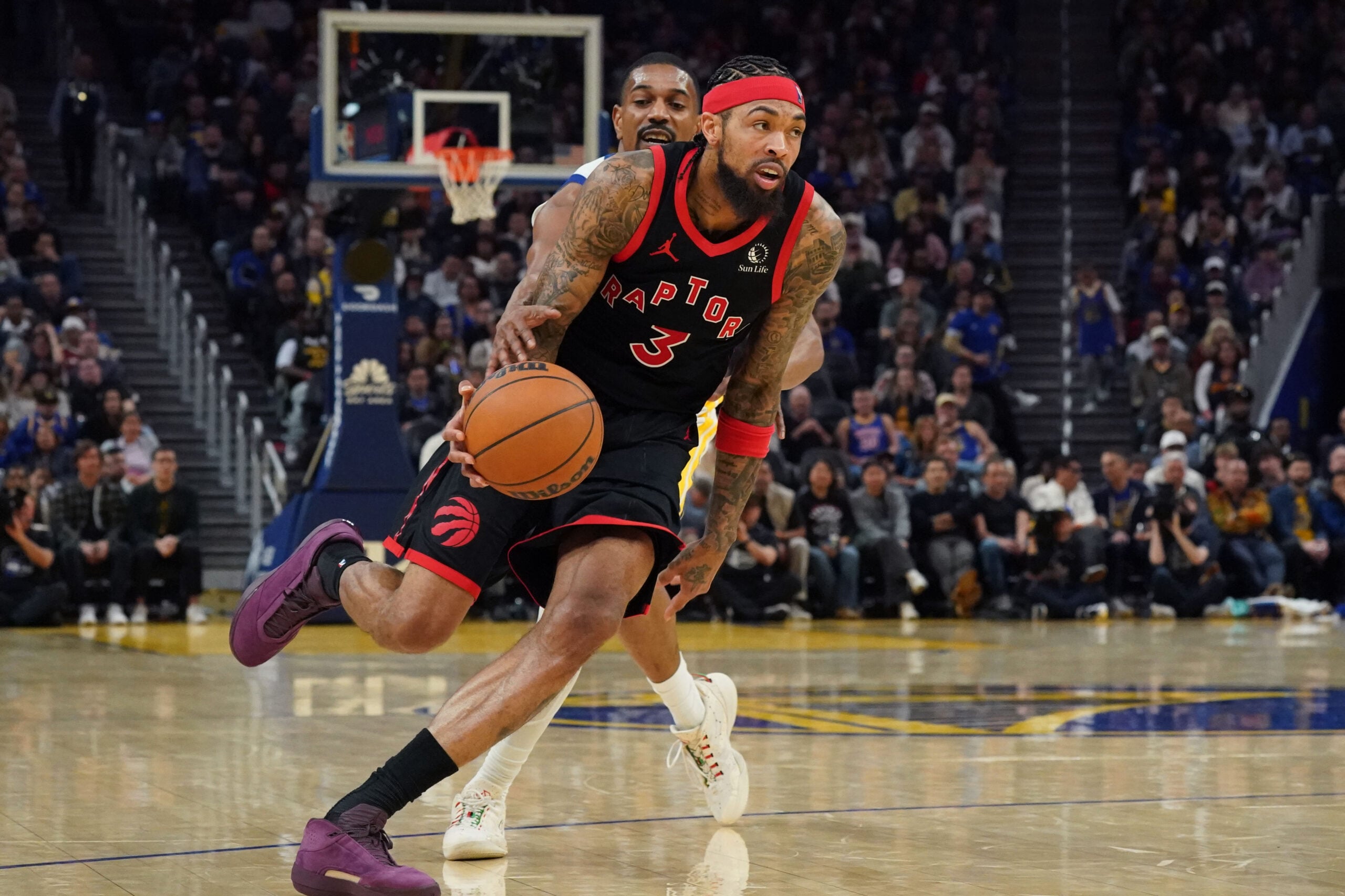 Jan 20, 2026; San Francisco, California, USA;  Toronto Raptors forward Brandon Ingram (3) drives by Golden State Warriors guard De'Anthony Melton (8) in the third quarter at Chase Center. Mandatory Credit: David Gonzales-Imagn Images