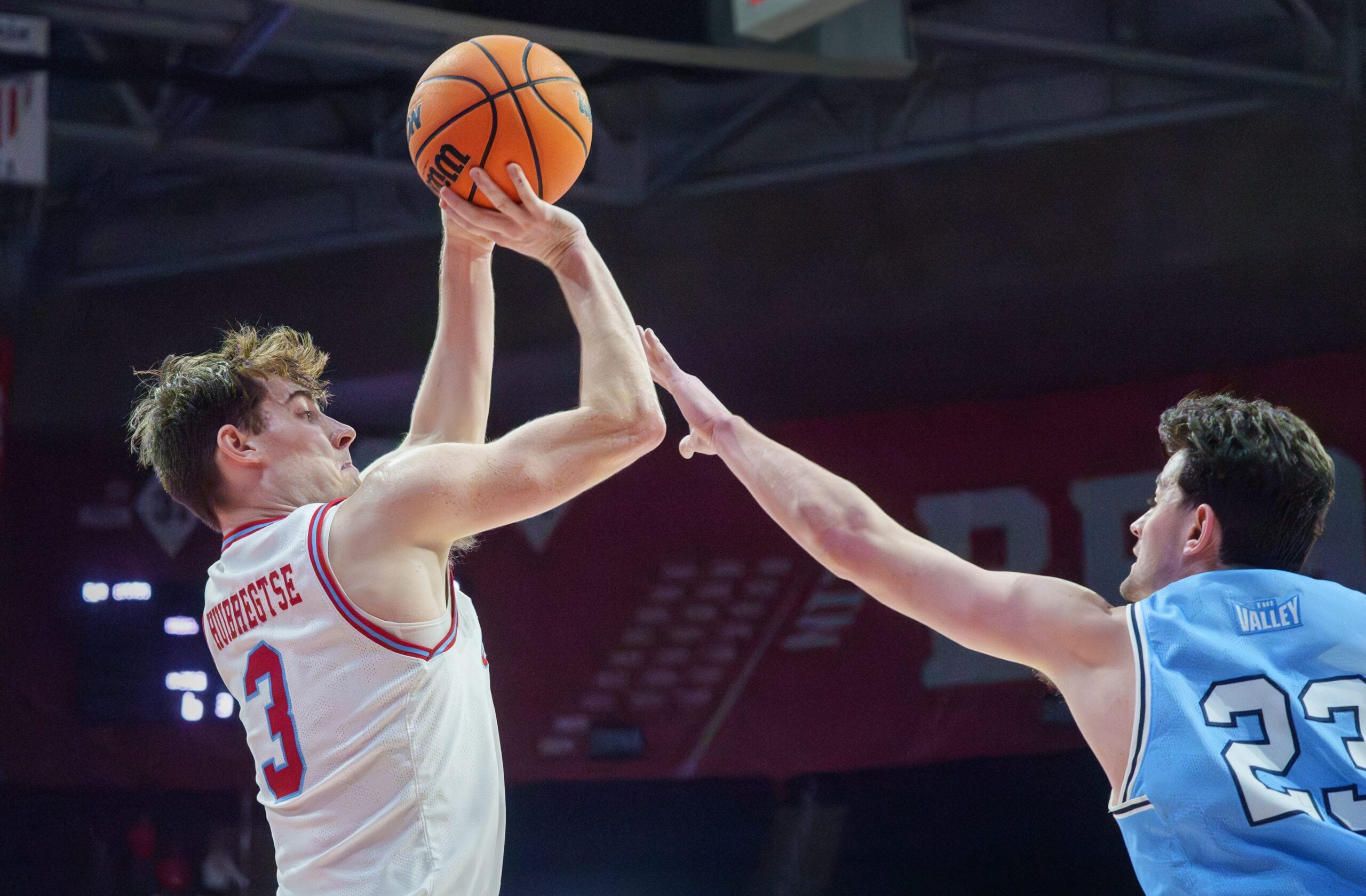 Bradley’s Alex Huibretgse, left, puts up a shot over Indiana State’s Ian Scott in the second half of their college basketball game Wednesday, Jan. 21, 2026 at Carver Arena. The Braves mounted a last-minute rally to defeat the Sycamores 75-68.