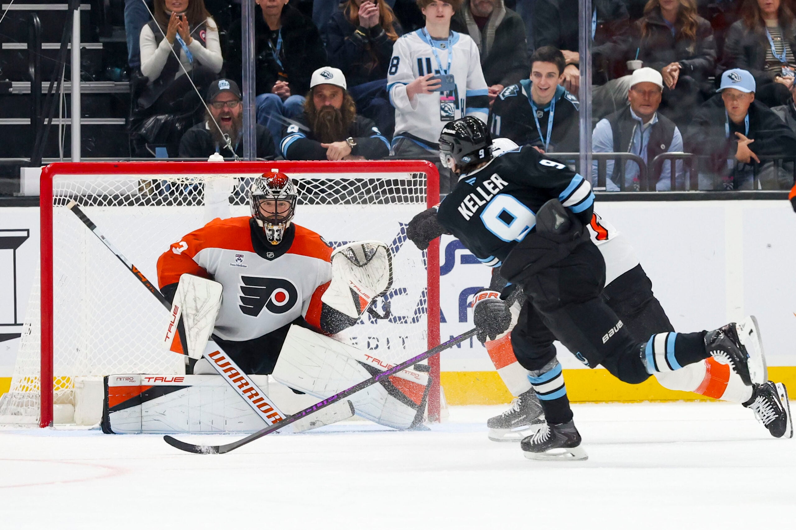 Jan 21, 2026; Salt Lake City, Utah, USA; Utah Mammoth right wing Clayton Keller (9) scores a goal against Philadelphia Flyers goaltender Samuel Ersson (33) to win the game in overtime at Delta Center. Mandatory Credit: Rob Gray-Imagn Images