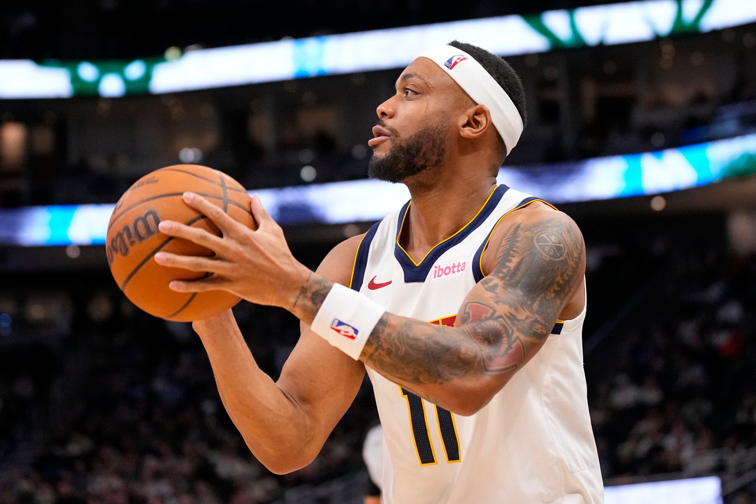 Jan 23, 2026; Milwaukee, Wisconsin, USA;  Denver Nuggets guard Bruce Brown (11) shoots during the fourth quarter against the Milwaukee Bucks at Fiserv Forum. Mandatory Credit: Jeff Hanisch-Imagn Images