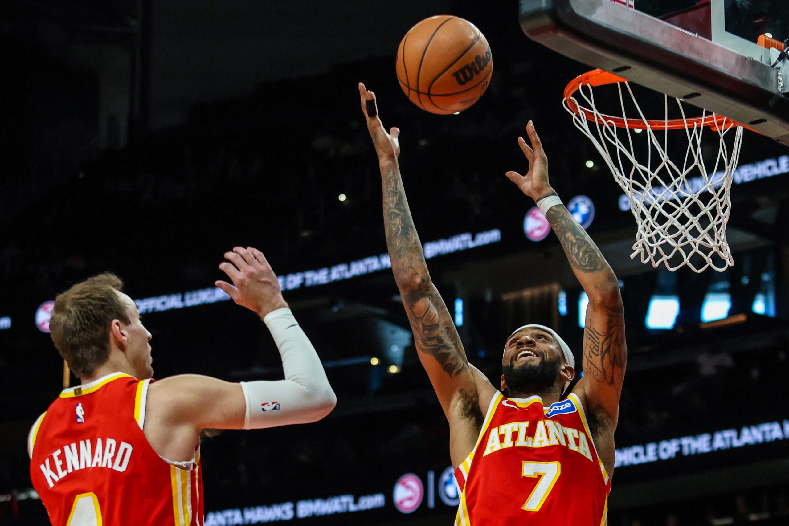 Jan 26, 2026; Atlanta, Georgia, USA; Atlanta Hawks guard Luke Kennard (4) and Atlanta Hawks guard Nickeil Alexander-Walker (7) jump for a rebound against the Indiana Pacers during the third quarter at State Farm Arena. Mandatory Credit: Jordan Godfree-Imagn Images