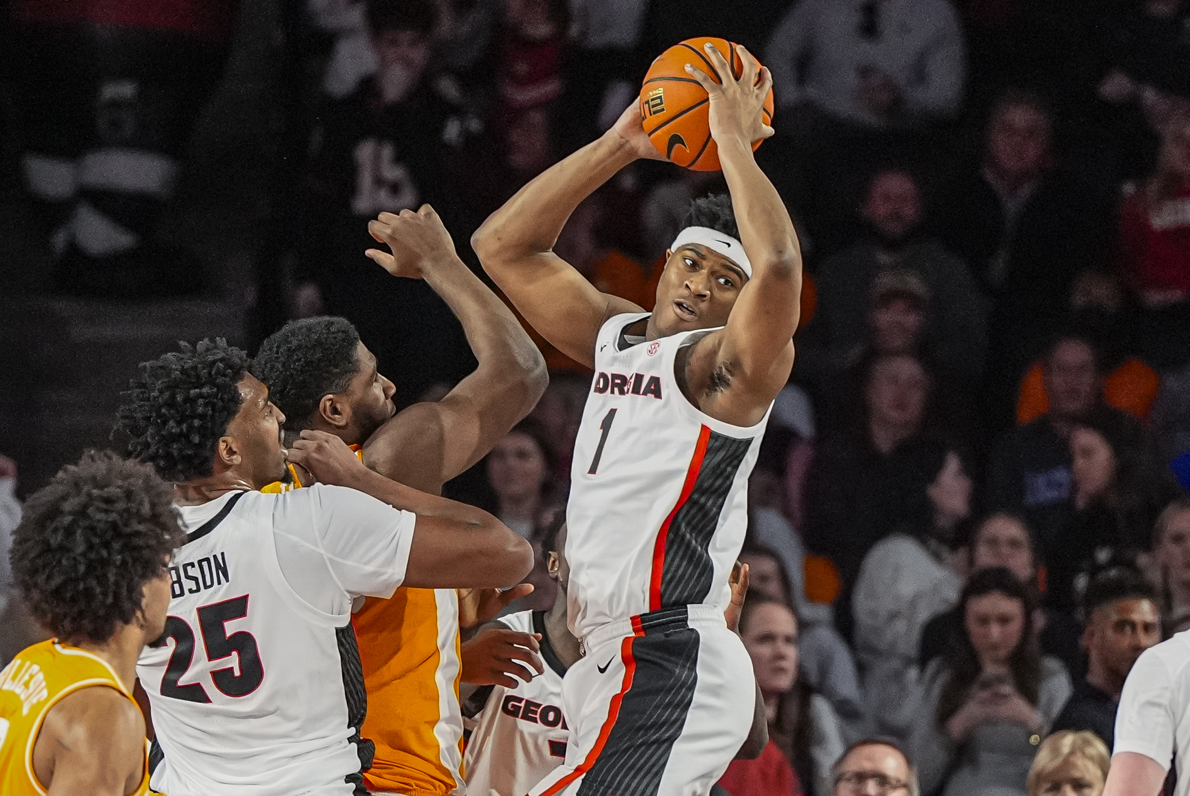 Jan 28, 2026; Athens, Georgia, USA; Georgia Bulldogs forward Kareem Stagg (1) grabs a rebound over Tennessee Volunteers forward Jaylen Carey (23) during the first half at Stegeman Coliseum. Mandatory Credit: Dale Zanine-Imagn Images