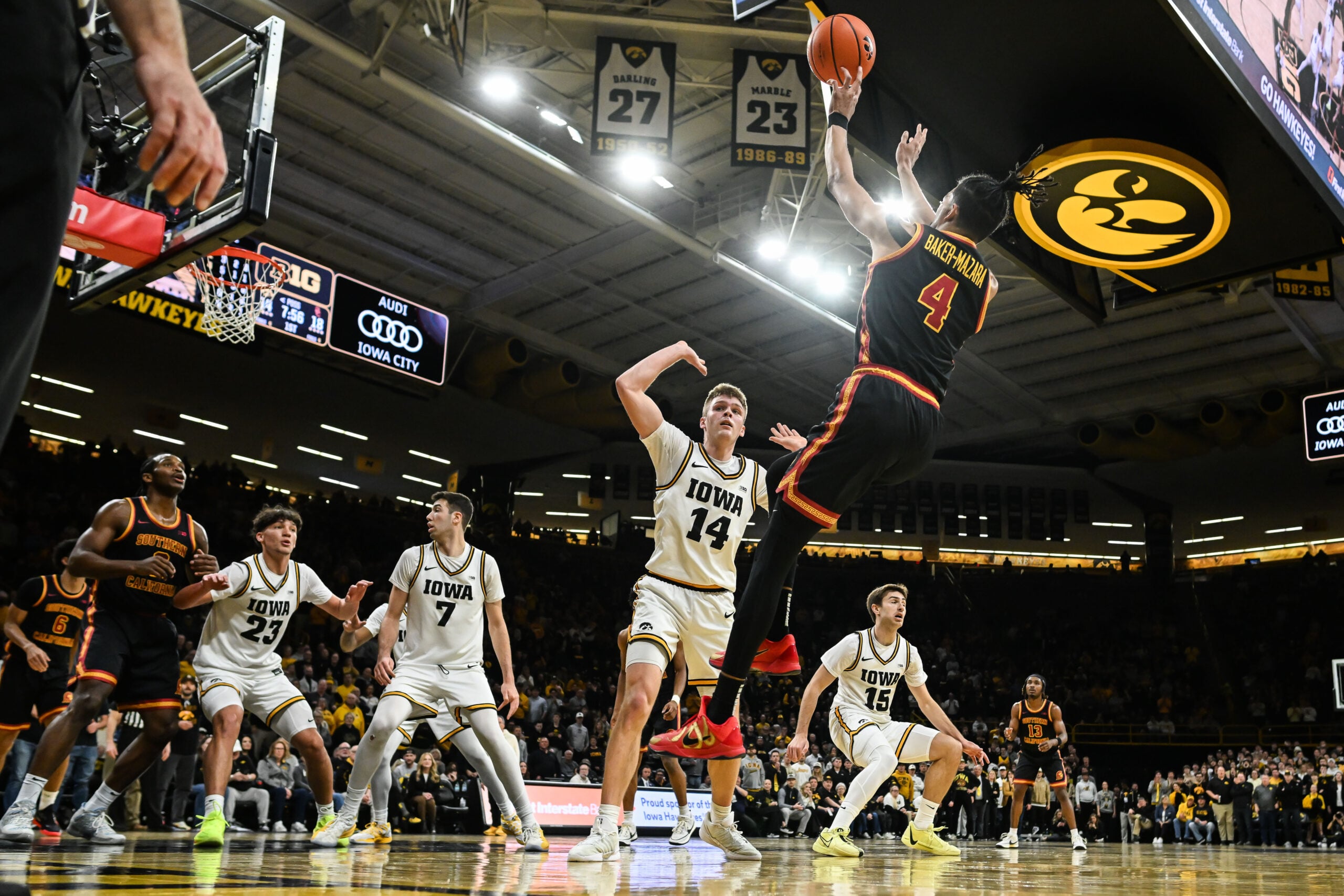 Jan 28, 2026; Iowa City, Iowa, USA; Iowa Hawkeyes guard Bennett Stirtz (14) defends the shot of Southern California Trojans forward Chad Baker-Mazara (4) as forward Alvaro Folgueiras (7) and guard Isaia Howard (23) and guard Brendan Hausen (15) look on during the first half at Carver-Hawkeye Arena. Mandatory Credit: Jeffrey Becker-Imagn Images