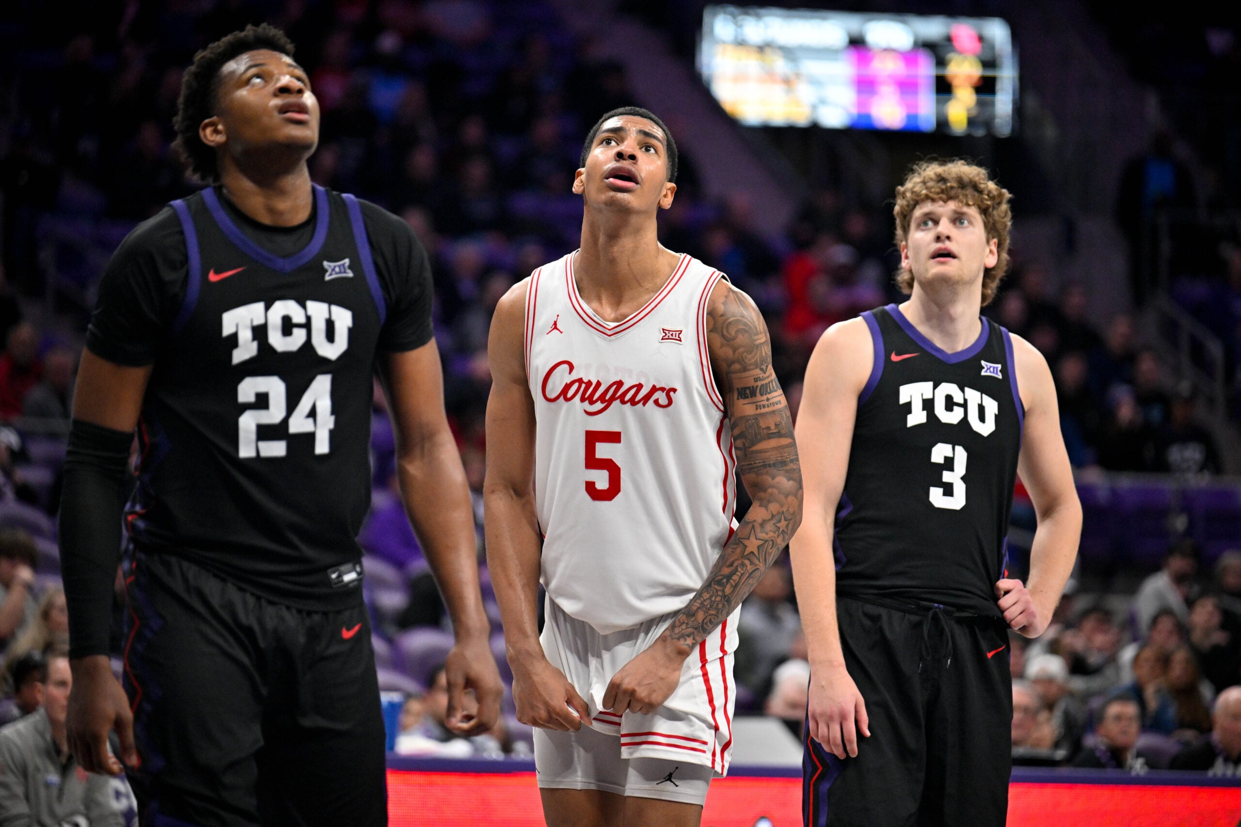 Jan 28, 2026; Fort Worth, Texas, USA; TCU Horned Frogs forward Xavier Edmonds (24) and guard Liutauras Lelevicius (3) and Houston Cougars forward Chris Cenac Jr. (5) look on during the game at Ed and Rae Schollmaier Arena. Mandatory Credit: Jerome Miron-Imagn Images