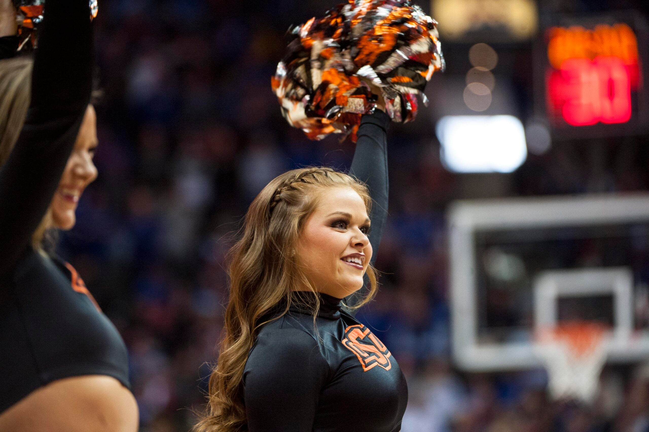 Mar 8, 2018; Kansas City, MO, United States; A Oklahoma State Cowboys cheerleader smiles in the first half against the Kansas Jayhawks during the semifinals of the Big 12 Tournament at Sprint Center. Mandatory Credit: Amy Kontras-Imagn Images