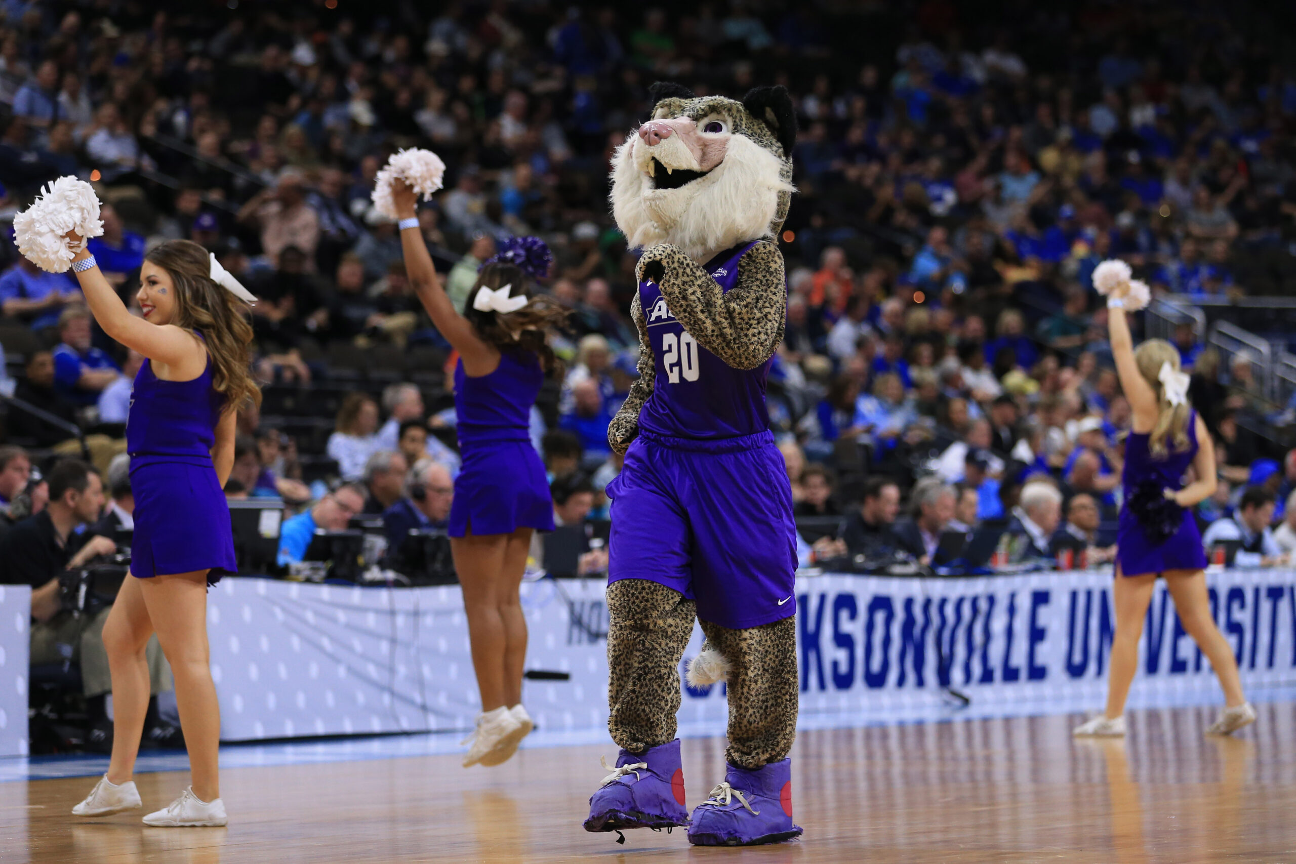 Mar 21, 2019; Jacksonville, FL, USA; The Abilene Christian Wildcats mascot and cheerleaders dance on the court during a stoppage in play against the Kentucky Wildcats the first half against the Kentucky Wildcats in the first round of the 2019 NCAA Tournament at Jacksonville Veterans Memorial Arena. Mandatory Credit: Matt Stamey-Imagn Images