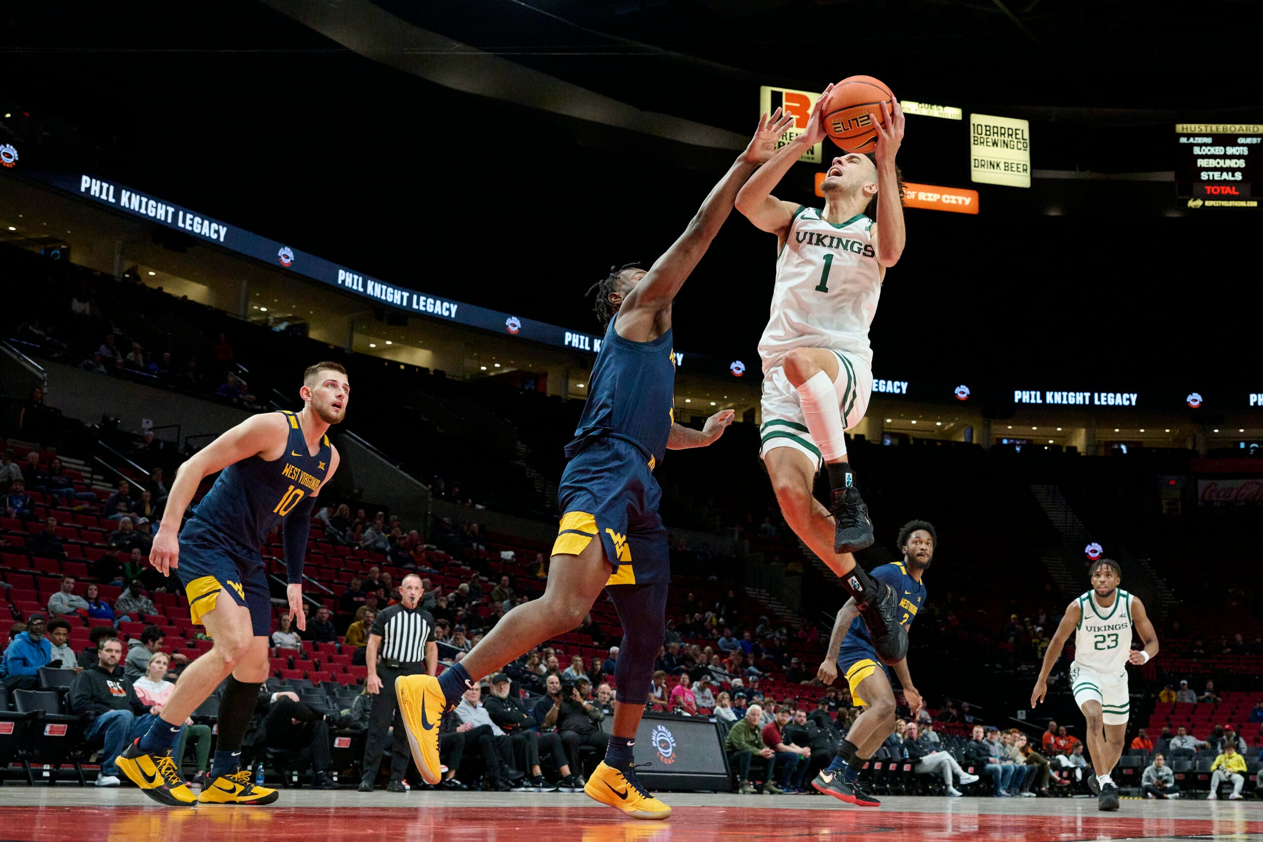 Nov 25, 2022; Portland, Oregon, USA; Portland State Vikings guard Cameron Parker (1) lays the ball up during the first half against West Virginia Mountaineers guard Joe Toussaint (5) at Moda Center. Mandatory Credit: Troy Wayrynen-Imagn Images