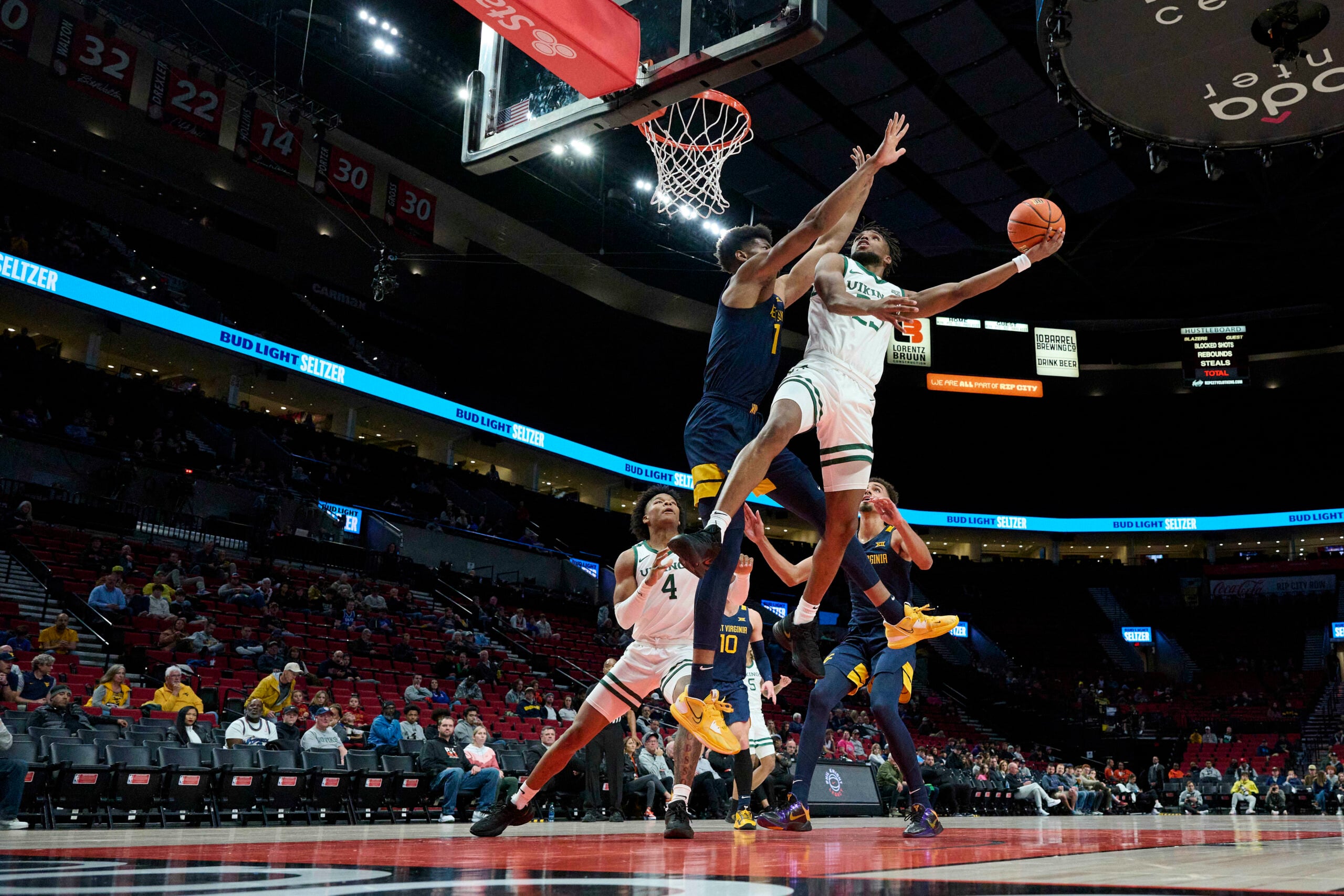 Nov 25, 2022; Portland, Oregon, USA; Portland State Vikings guard Jorell Saterfield (23) shoot a basket against West Virginia Mountaineers forward Mohamed Wague (11) during the first half at Moda Center. Mandatory Credit: Troy Wayrynen-Imagn Images
