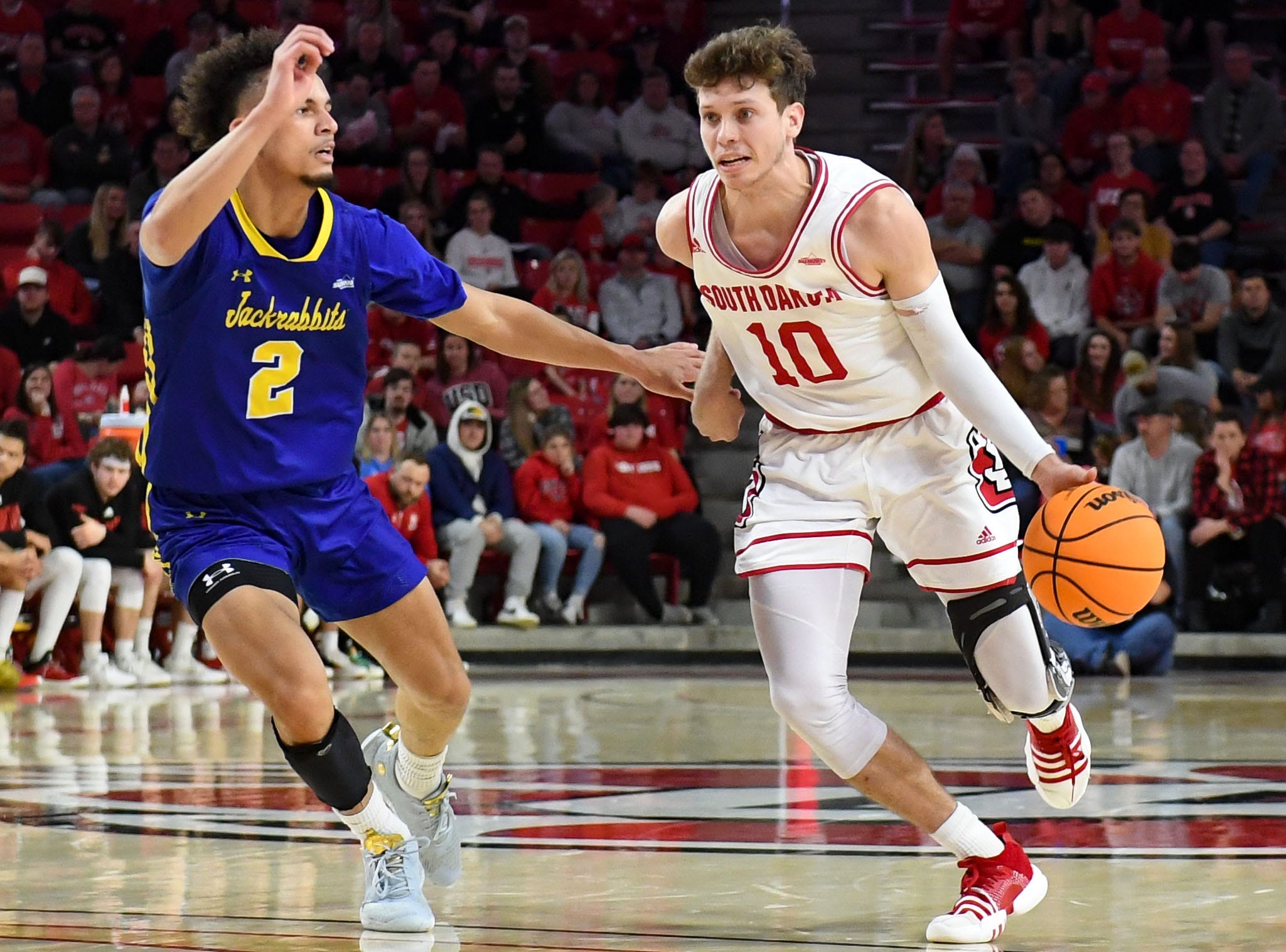 South Dakota   s A.J. Plitzuweit dribbles down the court while guarded by South Dakota State   s Zeke Mayo in a rivalry matchup on Saturday, January 14, 2023, at the Sanford Coyote Sports Center in Vermillion.

Men Rivalry Bball 004