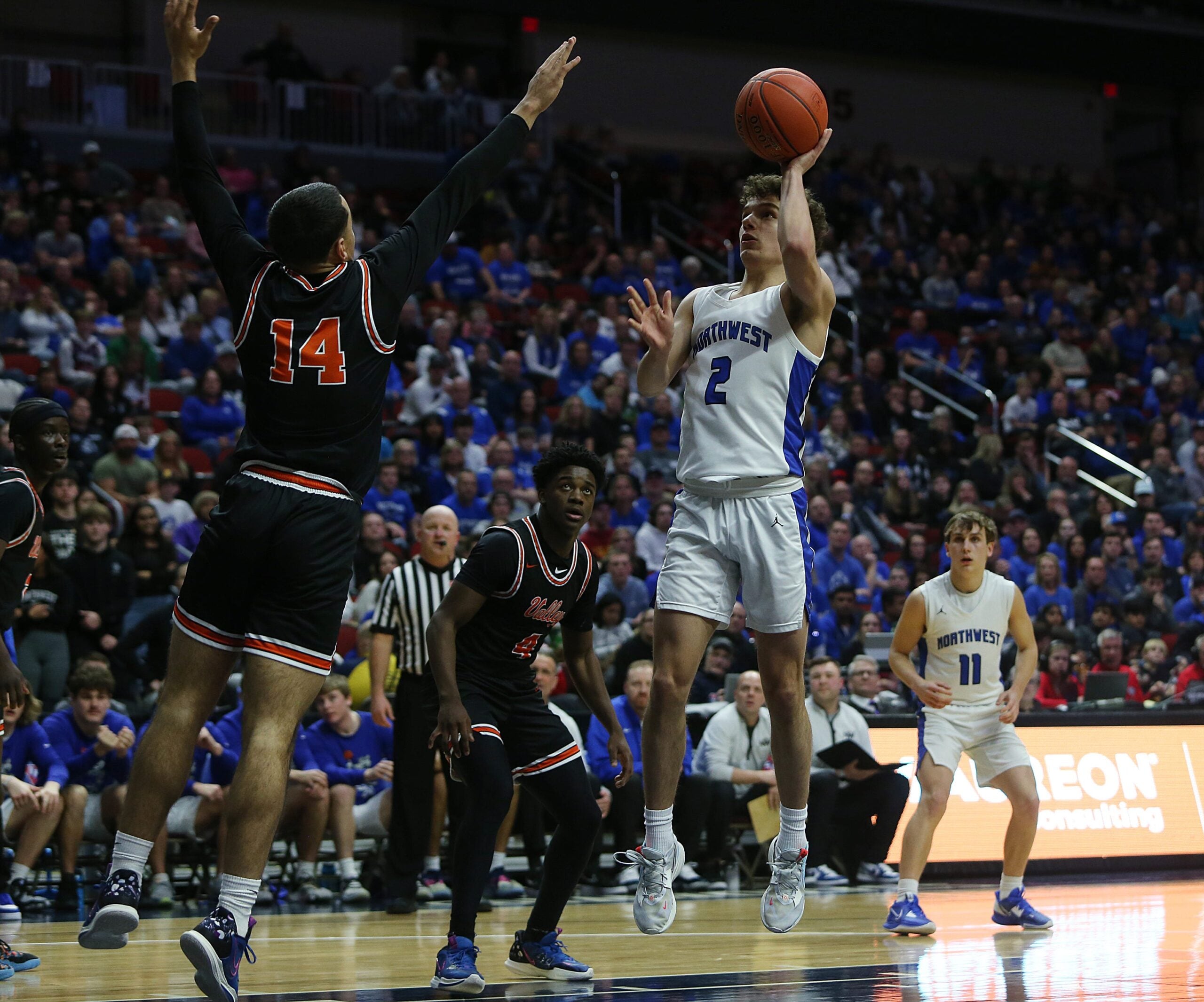 Waukee Northwest guard Cade Kelderman (2) takes a shot over Valley guard Trevian Carson (14) during the third quarter in the class 4A boys state basketball championship game at Wells Fargo Arena Friday, March 10, 2023, in Des Moines, Iowa.