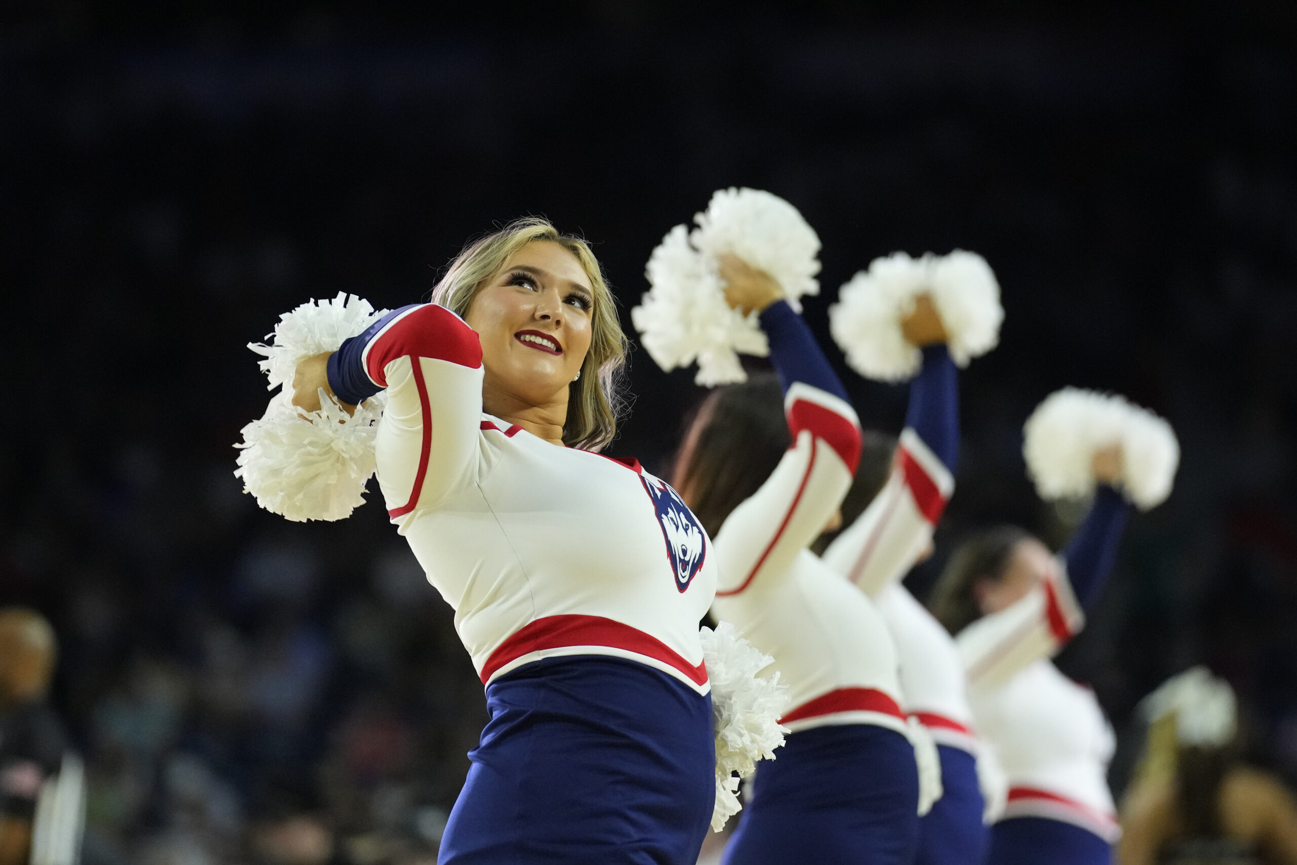 Apr 1, 2023; Houston, TX, USA; Connecticut Huskies cheerleaders perform against the Miami Hurricanes in the semifinals of the Final Four of the 2023 NCAA Tournament at NRG Stadium. Mandatory Credit: Robert Deutsch-Imagn Images