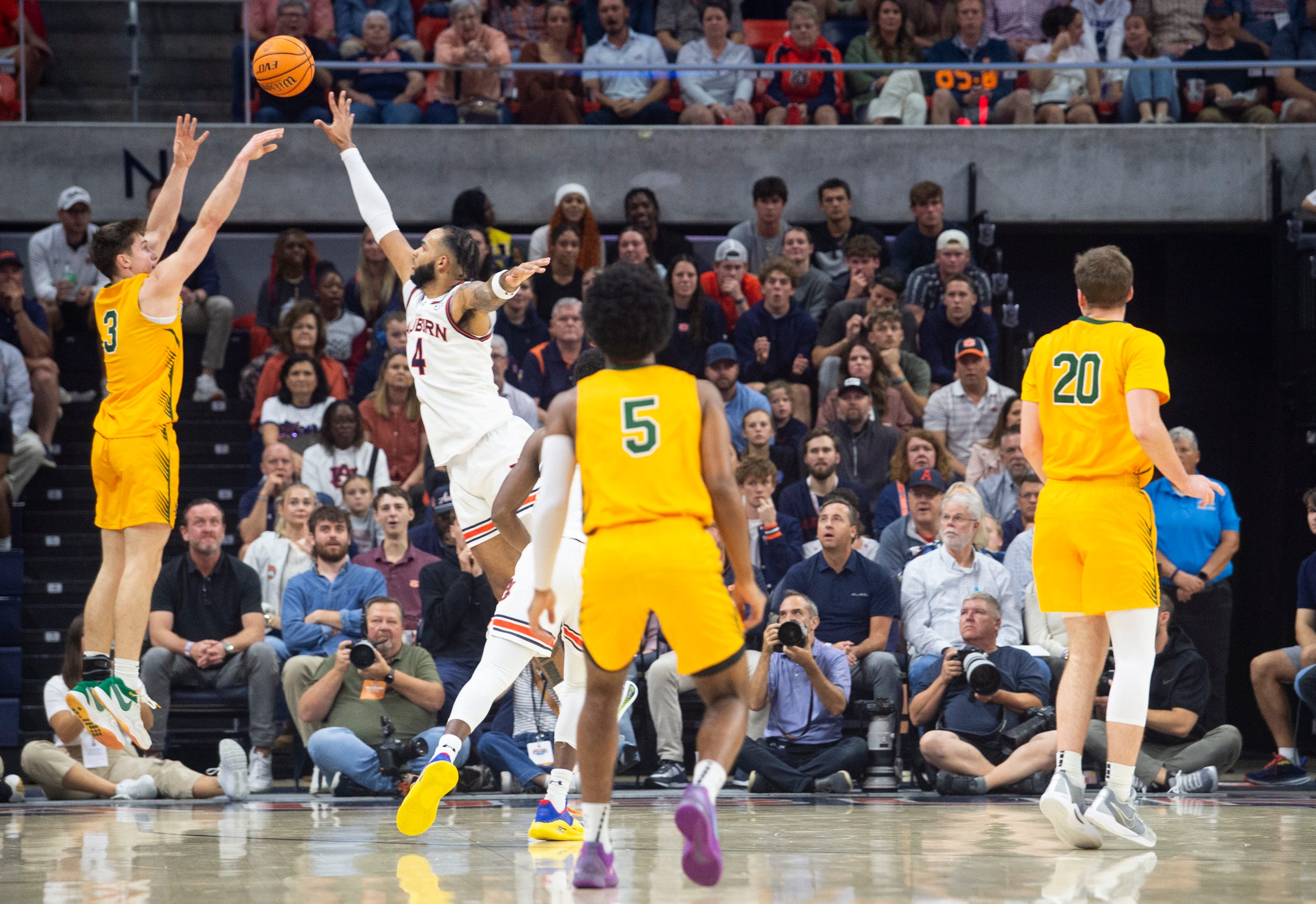 Vermont Catamounts guard TJ Hurley (3) shoots over Auburn Tigers forward Johni Broome (4) as Auburn Tigers take on Vermont Catamounts at Neville Arena in Auburn, Ala., on Wednesday, Nov. 6, 2024. Auburn Tigers leads Vermont Catamounts 46-21 at halftime.
