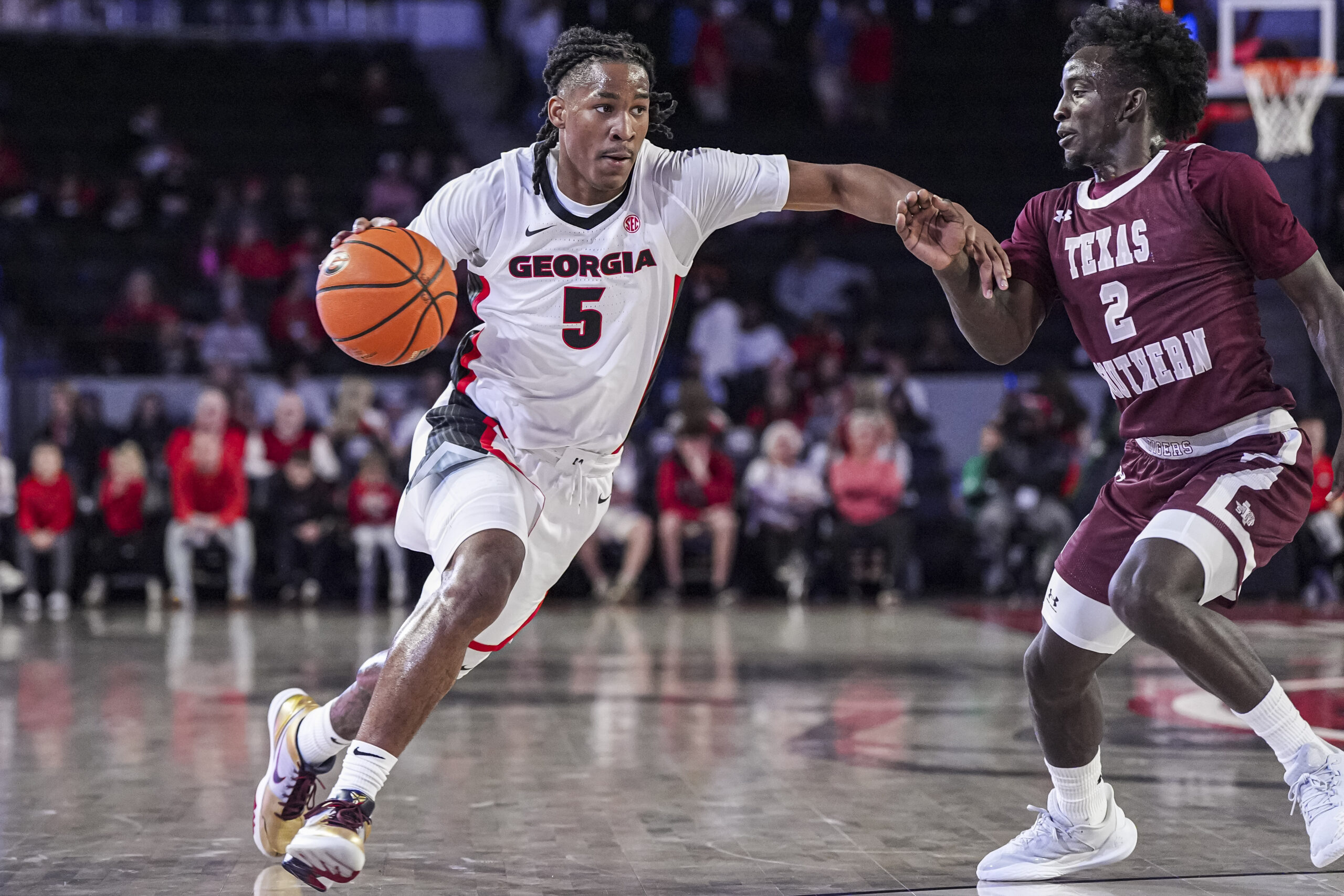 Nov 10, 2024; Athens, Georgia, USA; Georgia Bulldogs guard Silas Demary Jr. (5) dribbles against Texas Southern Tigers guard Kavion McClain (2) at Stegeman Coliseum. Mandatory Credit: Dale Zanine-Imagn Images