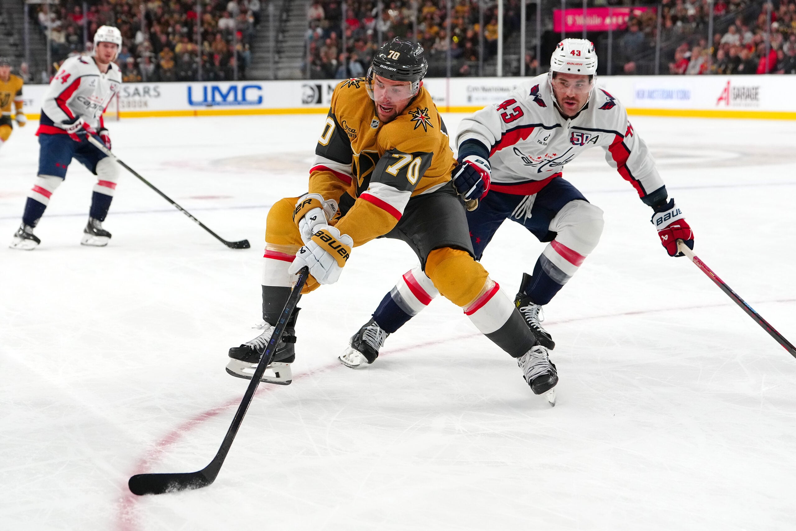 Nov 17, 2024; Las Vegas, Nevada, USA; Vegas Golden Knights left wing Tanner Pearson (70) controls the puck in front of Washington Capitals right wing Tom Wilson (43) during the second period at T-Mobile Arena. Mandatory Credit: Stephen R. Sylvanie-Imagn Images