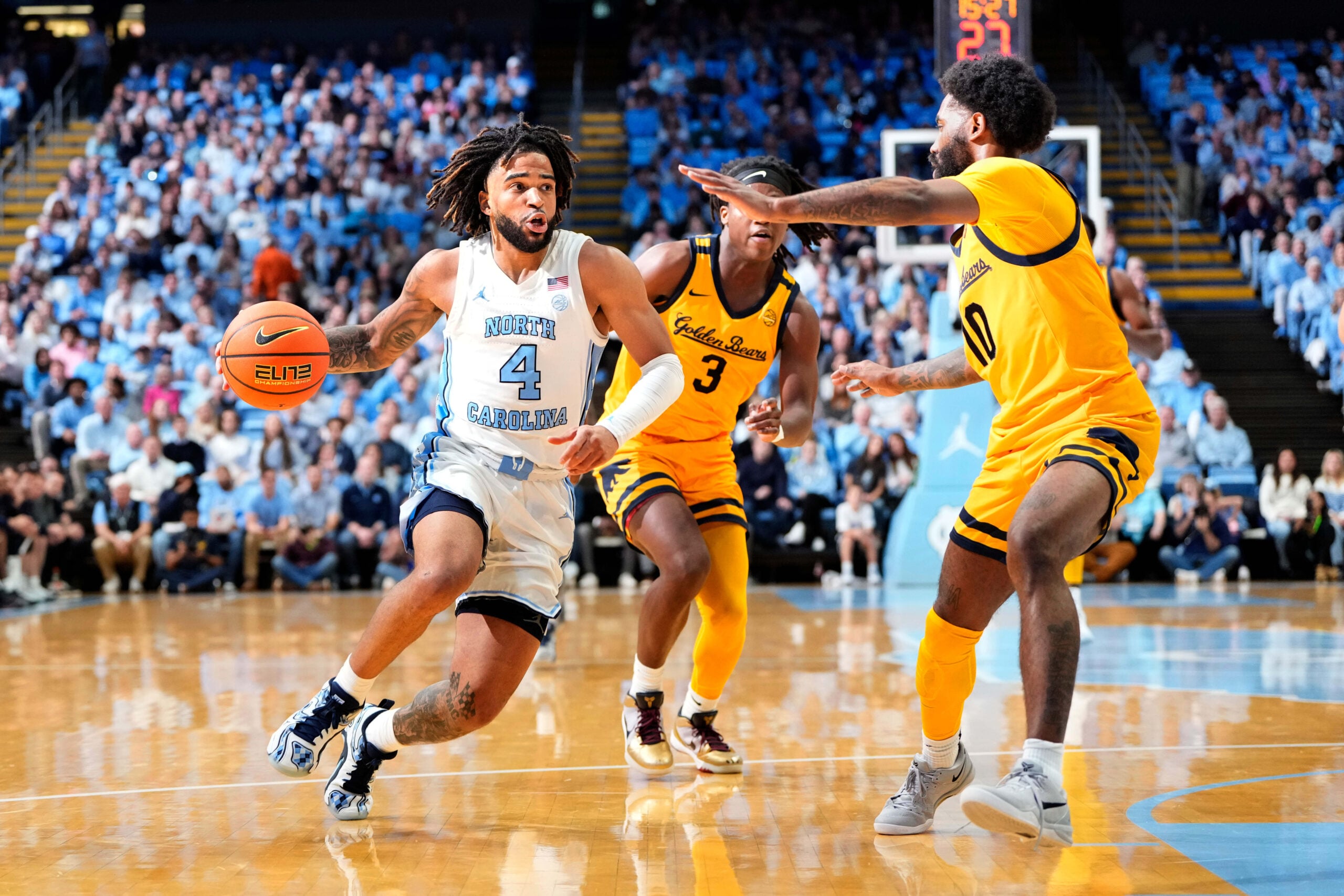 Jan 15, 2025; Chapel Hill, North Carolina, USA;  North Carolina Tar Heels guard RJ Davis (4) dribbles as California Golden Bears guard DJ Campbell (3) and guard Jovan Blacksher Jr. (10) defend in the second half at Dean E. Smith Center. Mandatory Credit: Bob Donnan-Imagn Images