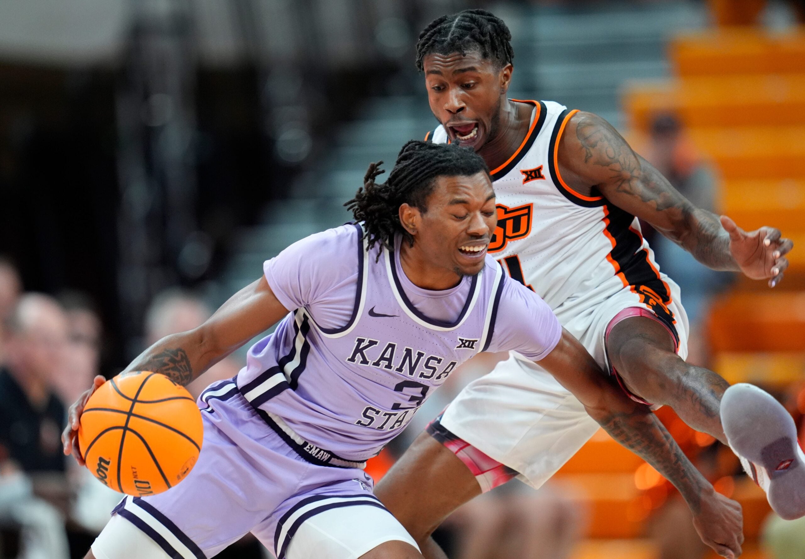 Kansas State Wildcats guard C.J. Jones (3) goes past Oklahoma State Cowboys guard Davonte Davis (4) during a men's BIG 12 basketball game between the Oklahoma State University Cowboys (OSU) and the Kansas State Wildcats at Gallagher-Iba Arena in Stillwater, Okla., Tuesday, Jan. 7, 2025.