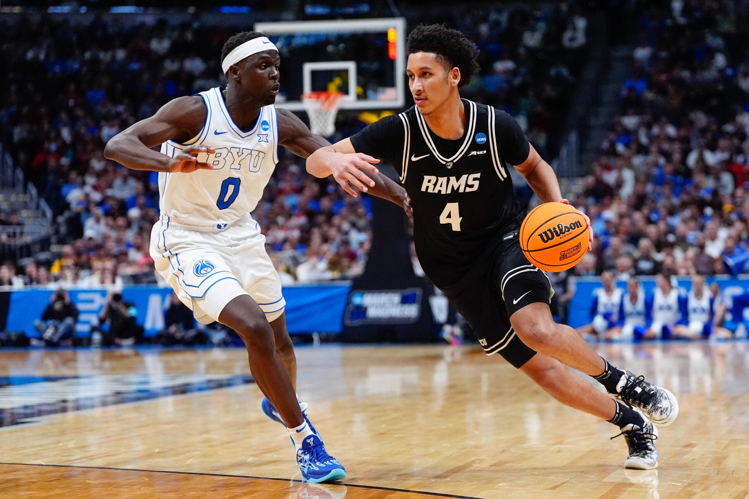 Mar 20, 2025; Denver, CO, USA; Brigham Young Cougars forward Mawot Mag (0) defends against VCU Rams forward Jack Clark (4) during the second half in the first round of the NCAA Tournament at Ball Arena. Mandatory Credit: Ron Chenoy-Imagn Images