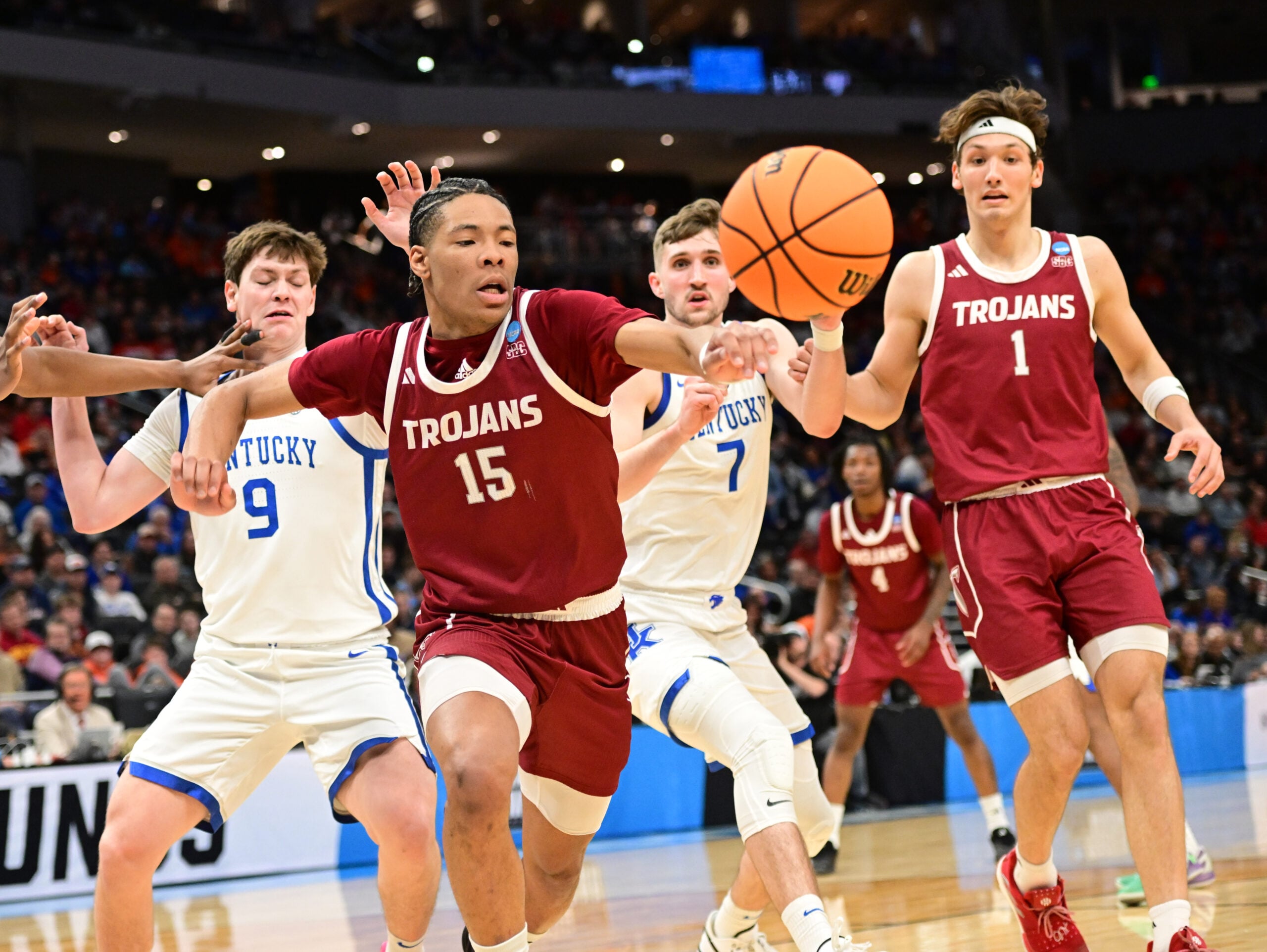 Mar 21, 2025; Milwaukee, WI, USA; Troy Trojans forward Jackson Fields (15) and Kentucky Wildcats forward Trent Noah (9) chase after a loose ball during the second half at Fiserv Forum. Mandatory Credit: Benny Sieu-Imagn Images