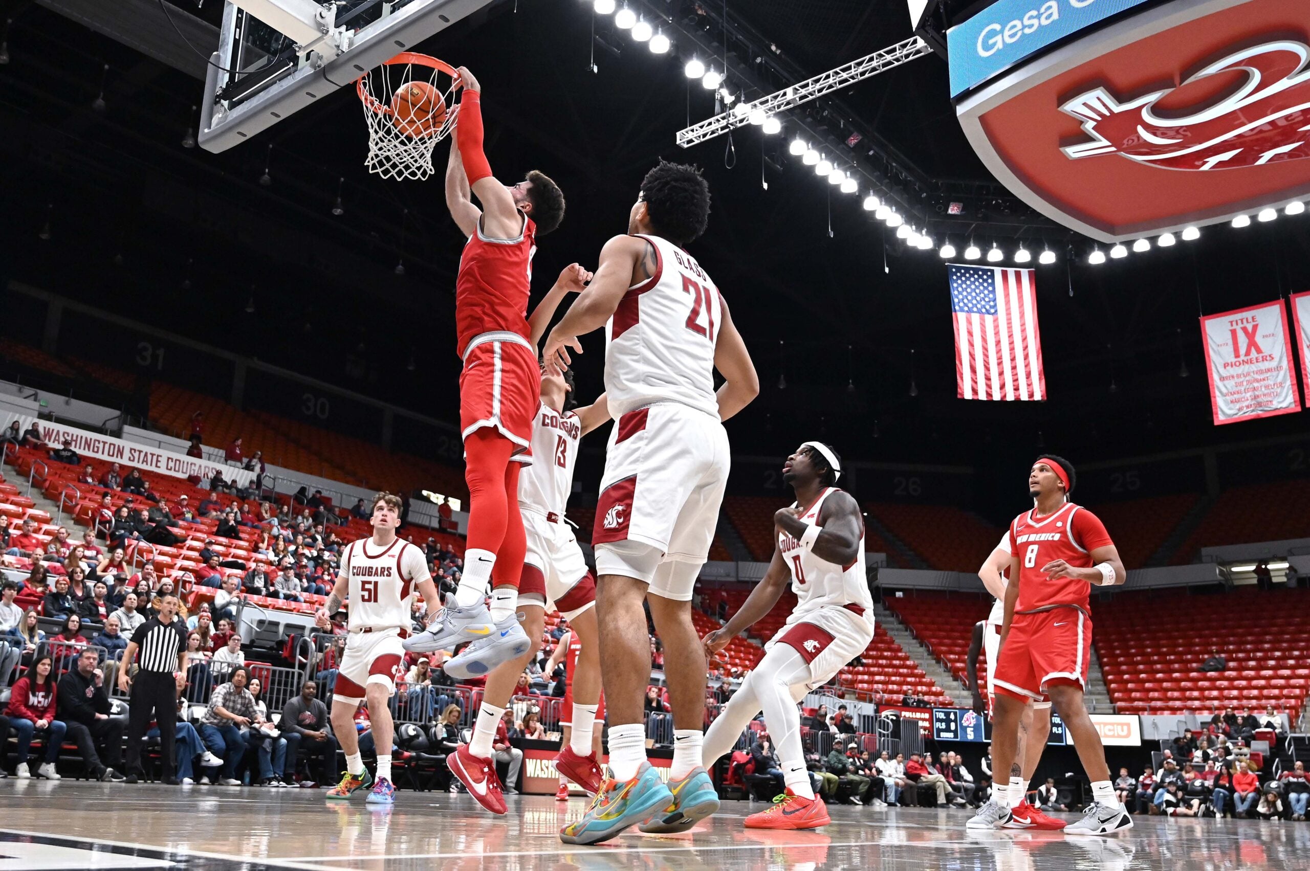 Oct 25, 2025; Pullman, WA, USA; New Mexico Lobos forward Tomislav Buljan (10) dunks the ball against Washington State Cougars guard Adria Rodriguez (13) in the first half at Friel Court at Beasley Coliseum. Mandatory Credit: James Snook-Imagn Images
